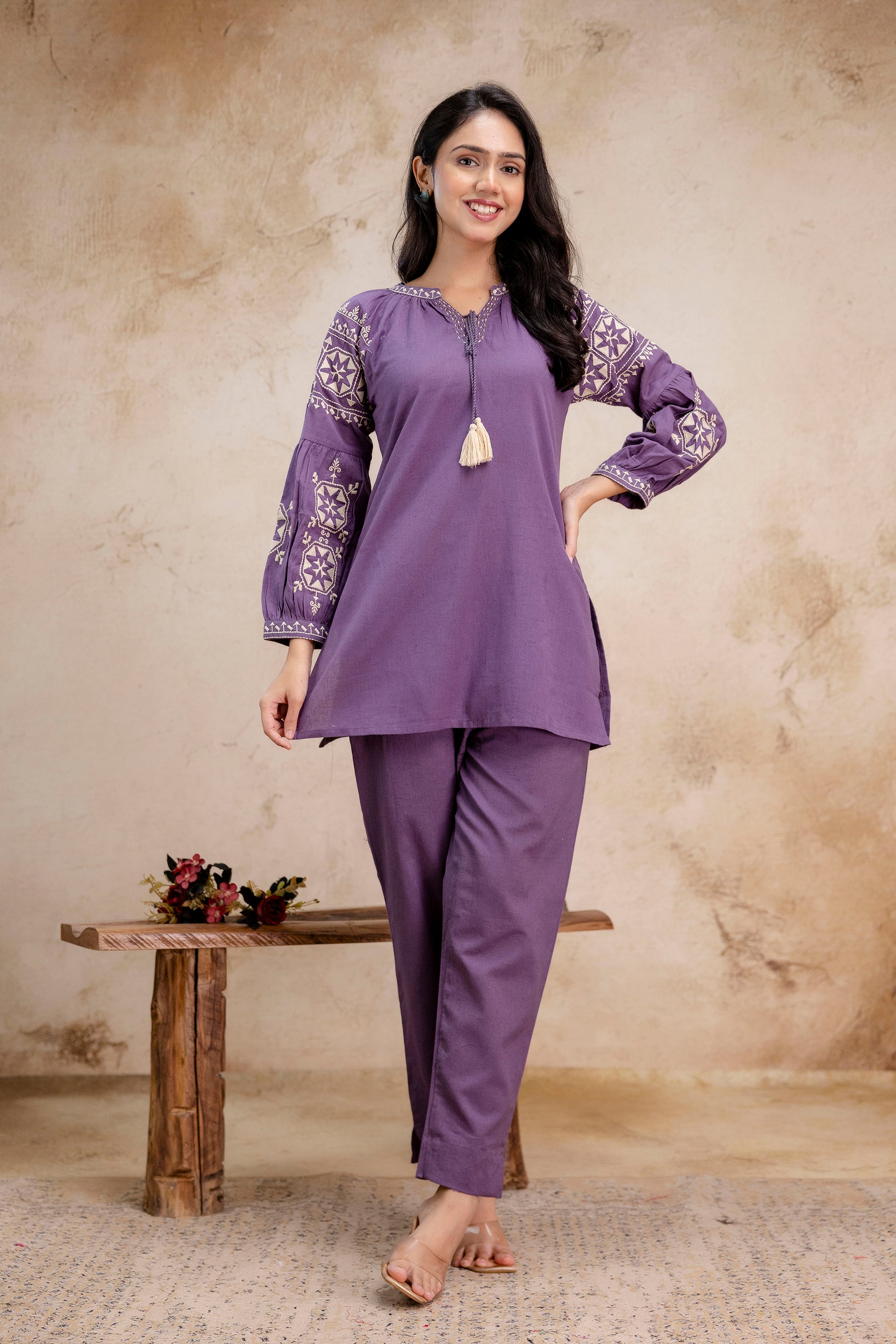 1. Tanauri lavender cotton kurti set with embroidered balloon sleeves and tassel tie
2. Lavender embroidered cotton kurti by Tanauri with full sleeves and straight pants
3. Front view of Tanauri ethnic lavender kurti and pant set – cotton fabric
4. Elegant balloon sleeve lavender cotton kurti outfit by Tanauri for women
5. Tanauri two-piece lavender ethnic set with tassel detail and floral embroidery
6. Comfortable lavender Tanauri kurti set with loose-fit pants – cotton wear
7. Tanauri cotton