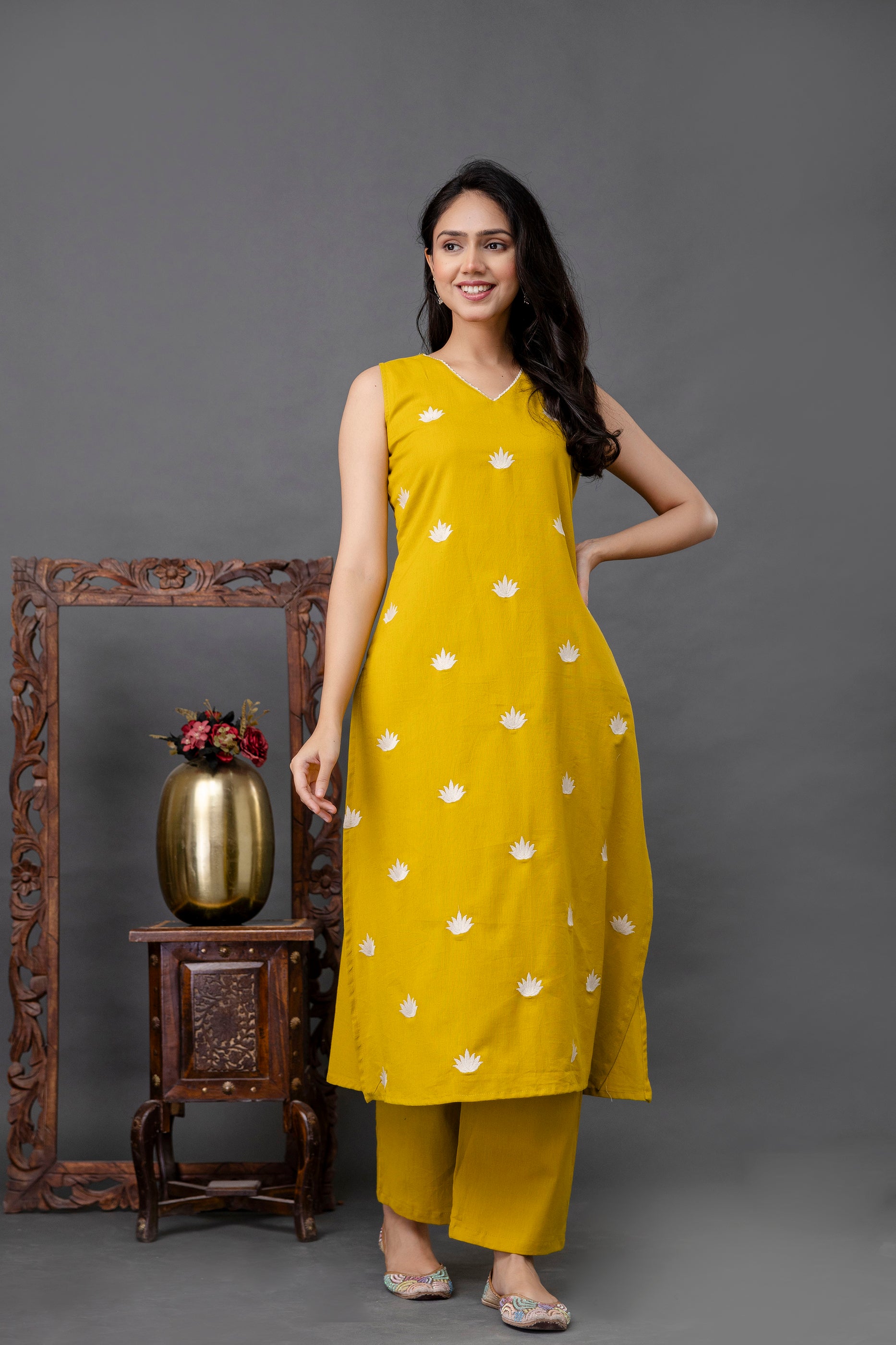 Sleeveless mustard yellow kurti adorned with delicate white lotus motifs
Features a subtle V-neckline and a straight silhouette with side slits
Lightweight cotton fabric offering breathable comfort for everyday wear
Simple yet elegant design perfect for casual outings, office wear, or summer styling
Ethnic-inspired hand-block look with a contemporary sleeveless twist