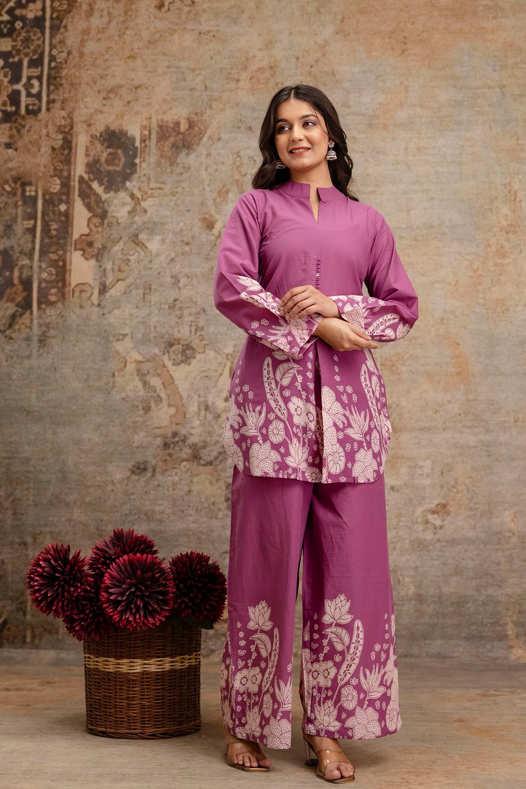 1. Mauve floral printed co-ord set for women – cotton fabric
2. Mauve long top and wide-leg pants with white ethnic print
3. Floral printed mauve kurti and trouser set – front view
4. Mauve co-ord set with white block print on sleeves and hem
5. Elegant two-piece kurti set in mauve cotton with floral details
6. Mauve ethnic wear set with full sleeves and front slit kurti
7. Comfortable cotton co-ord set with floral border print – mauve
8. Mauve kurti set with straight pants and printed cuffs