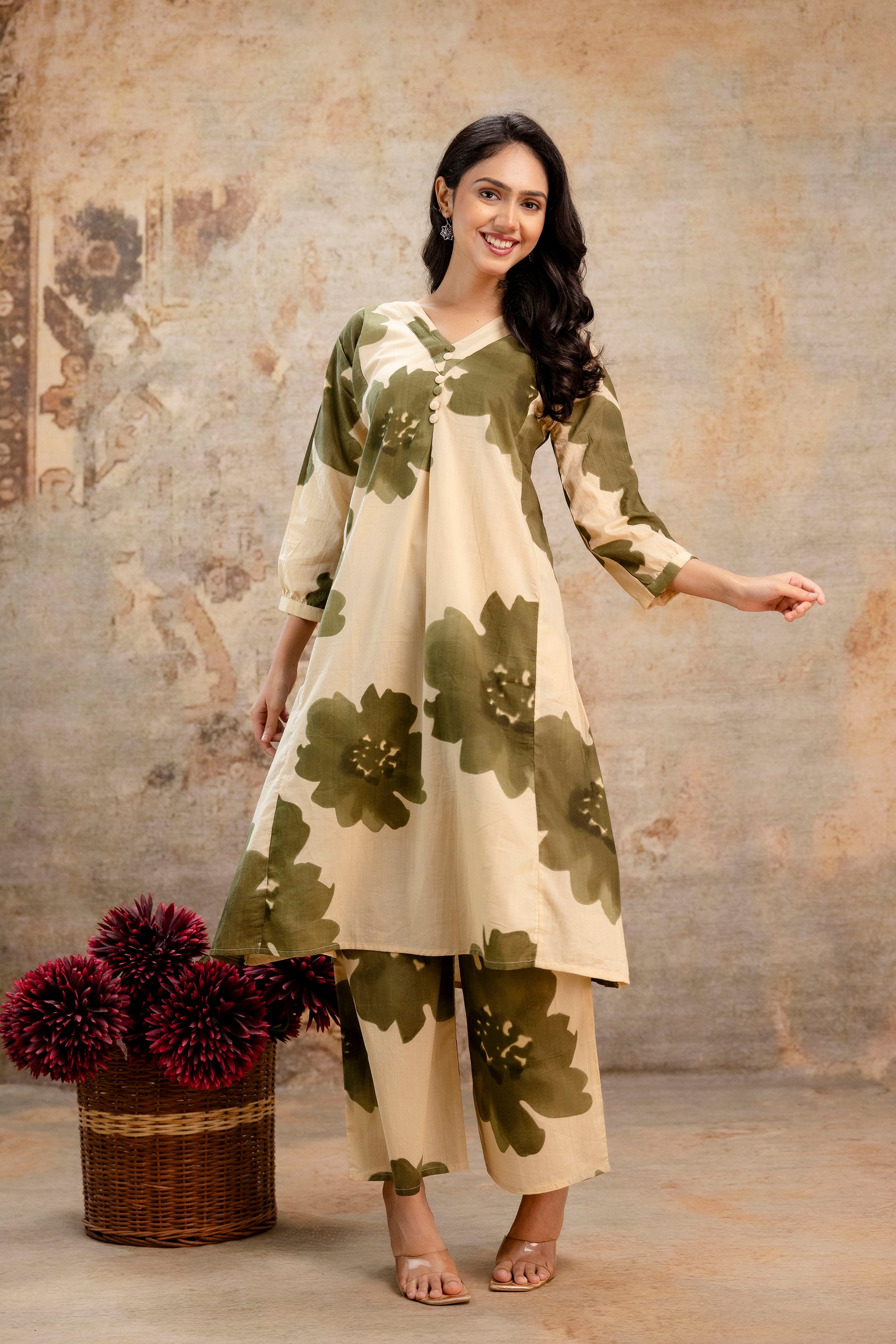 Beige and olive green floral print kurti set for women

A-line cotton kurti with oversized green flower motifs

V-neck ethnic kurti with 3/4th sleeves, paired with matching printed pants

Comfortable and stylish Indo-western kurti for daily wear and casual outings

Modern floral printed kurti set perfect for summer and festive gatherings

