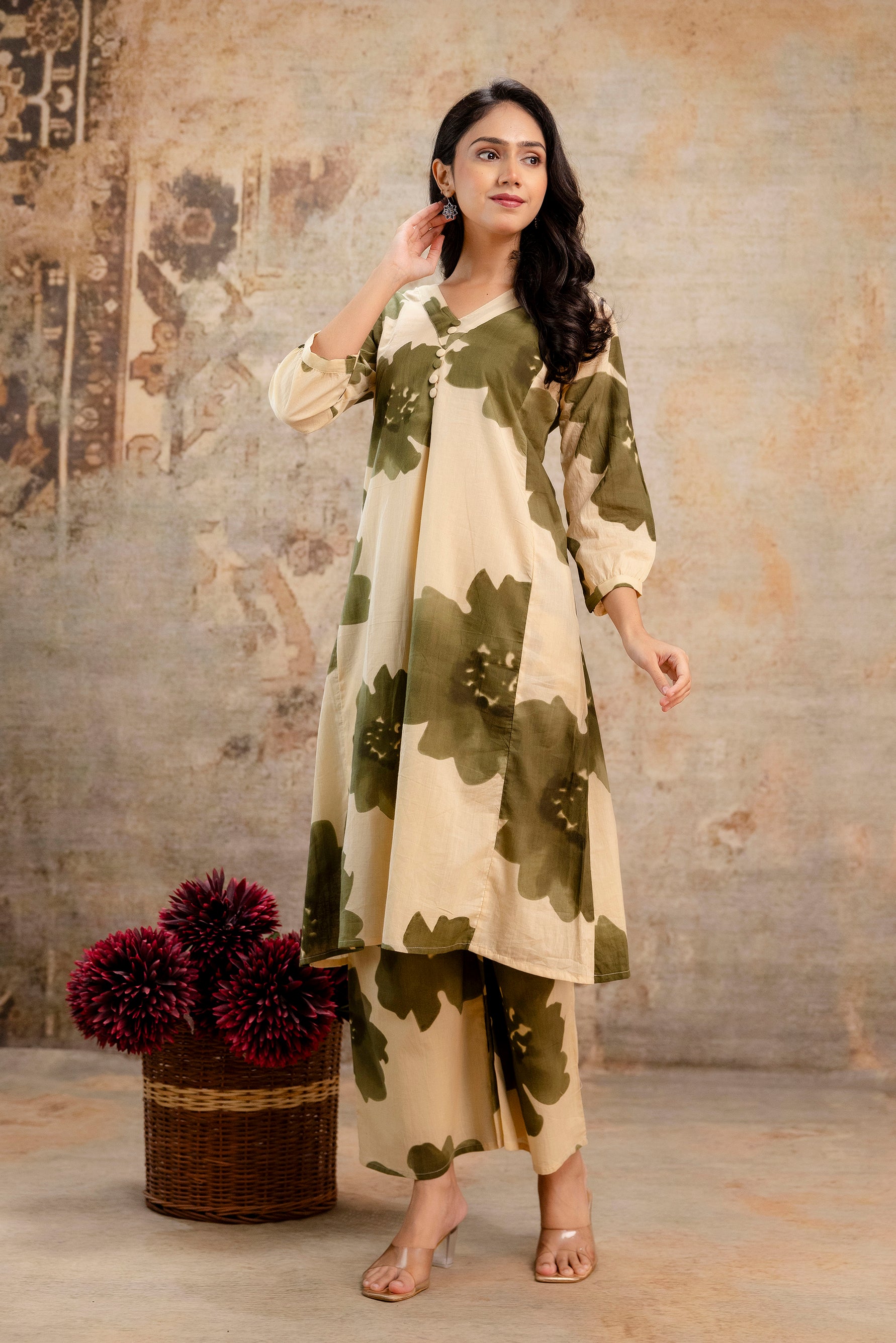 Elegant beige kurti with bold olive green floral print

Features a V-neckline and relaxed A-line silhouette

3/4th gathered sleeves for a casual-chic touch

Made from breathable cotton, ideal for summer wear

Styled with matching printed straight pants for a coordinated ethnic look