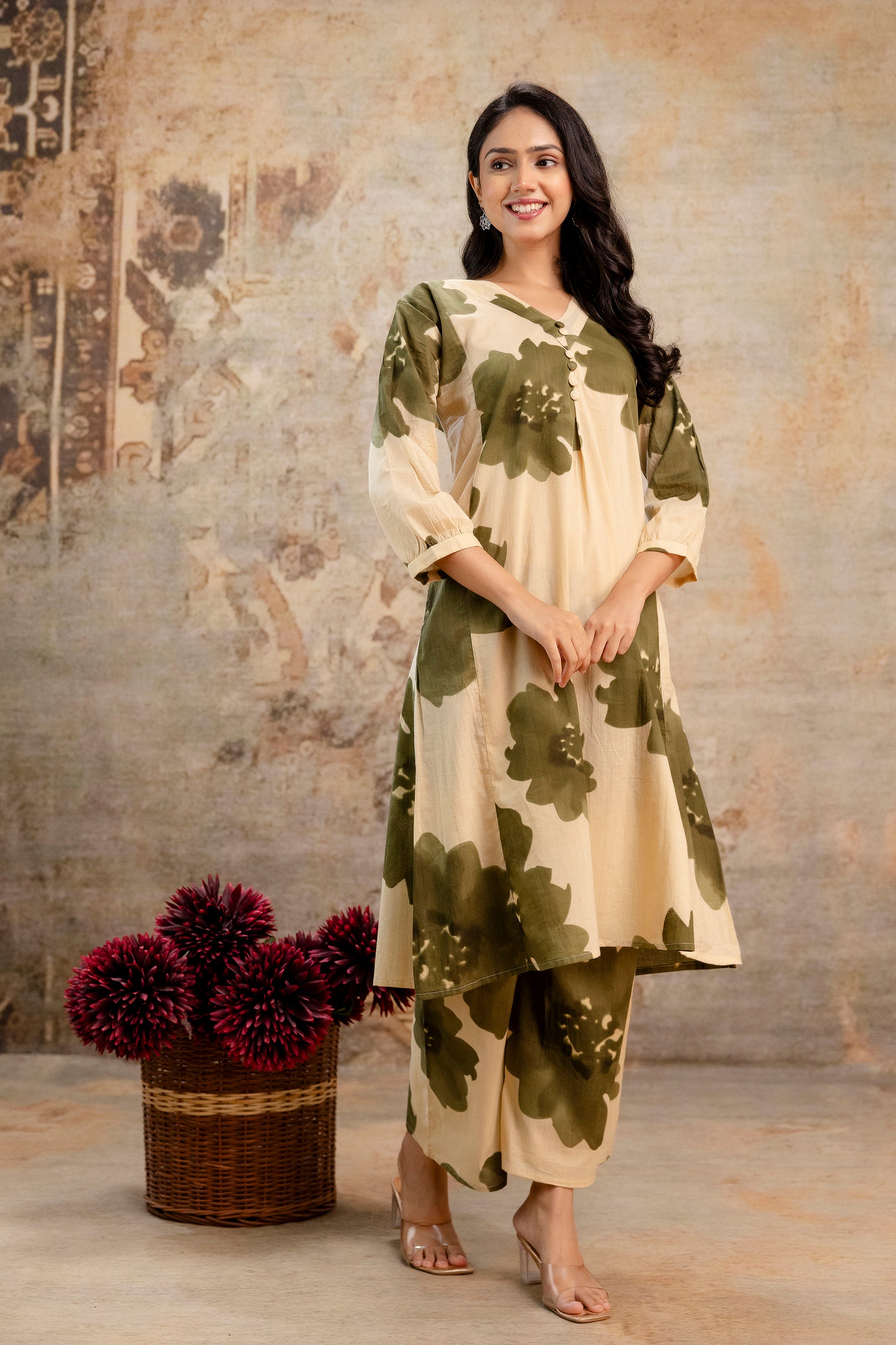 Beige cotton kurti with oversized olive floral print

Features a flattering V-neck and pleated front design

3/4th sleeves with subtle cuff detailing

Lightweight, breathable fabric for everyday wear

Paired with matching floral print pants for a complete look