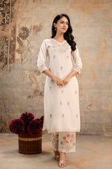 Woman wearing cream embroidered cotton kurti and pants set by Tanauri
Tanauri cream kurti with delicate floral embroidery and matching pants
Elegant Tanauri ethnic cotton kurti set in cream with pastel embroidery
Subtle floral-embroidered cream kurti set by Tanauri – soft and graceful look