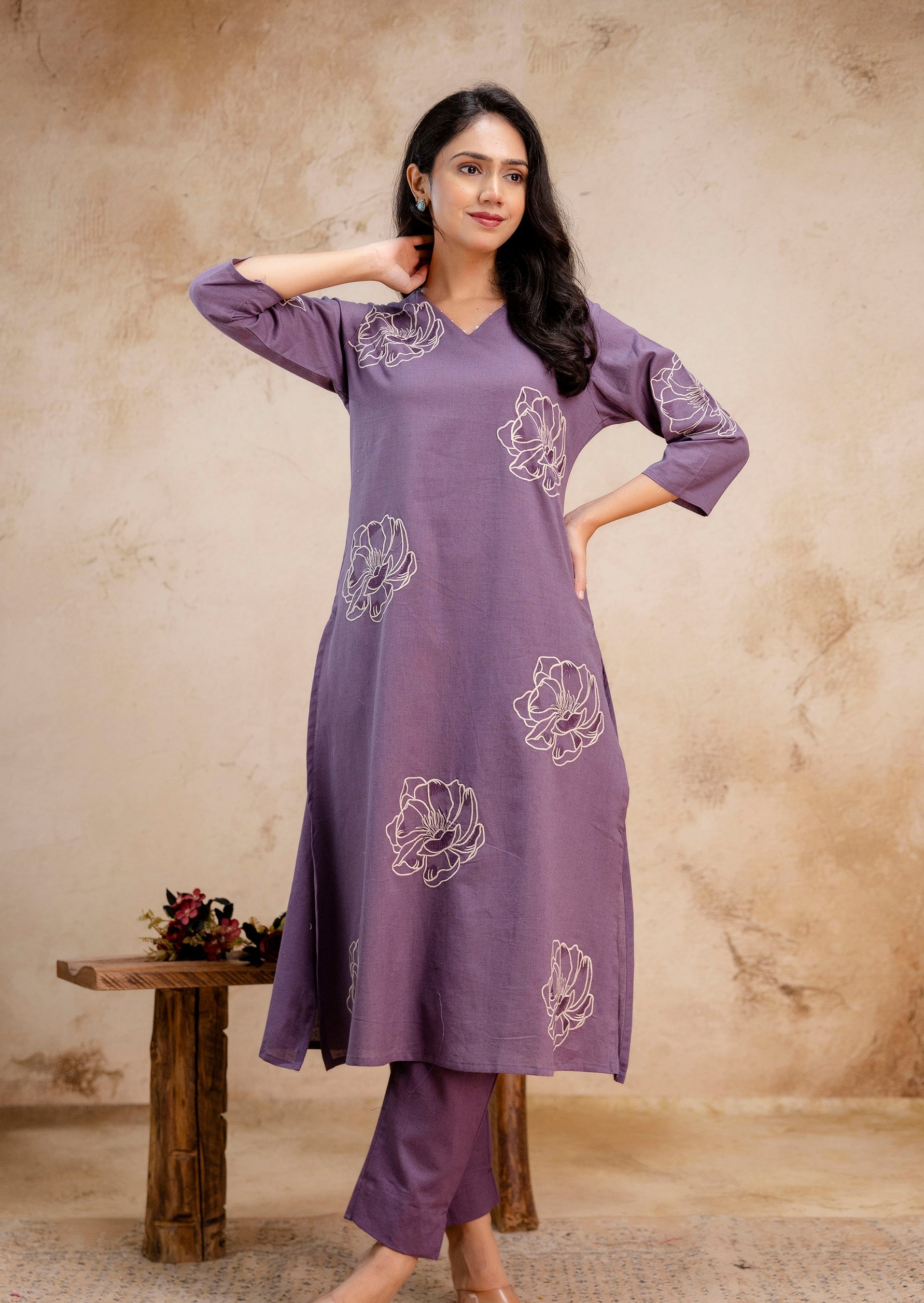 1. Tanauri lavender cotton kurti set with floral embroidery – elegant relaxed pose  
2. Lavender embroidered kurti with matching pants – Tanauri cotton ethnic wear  
3. Model in lavender kurti set with side slits and floral motifs – Tanauri design  
4. Tanauri cotton kurti and pants in soft lavender with white stitched florals  
5. Stylish lavender ethnic set with floral embroidery – Tanauri front pose  
6. Relaxed fit lavender kurti outfit for women – Tanauri embroidered cotton wear  
7. Tanauri three