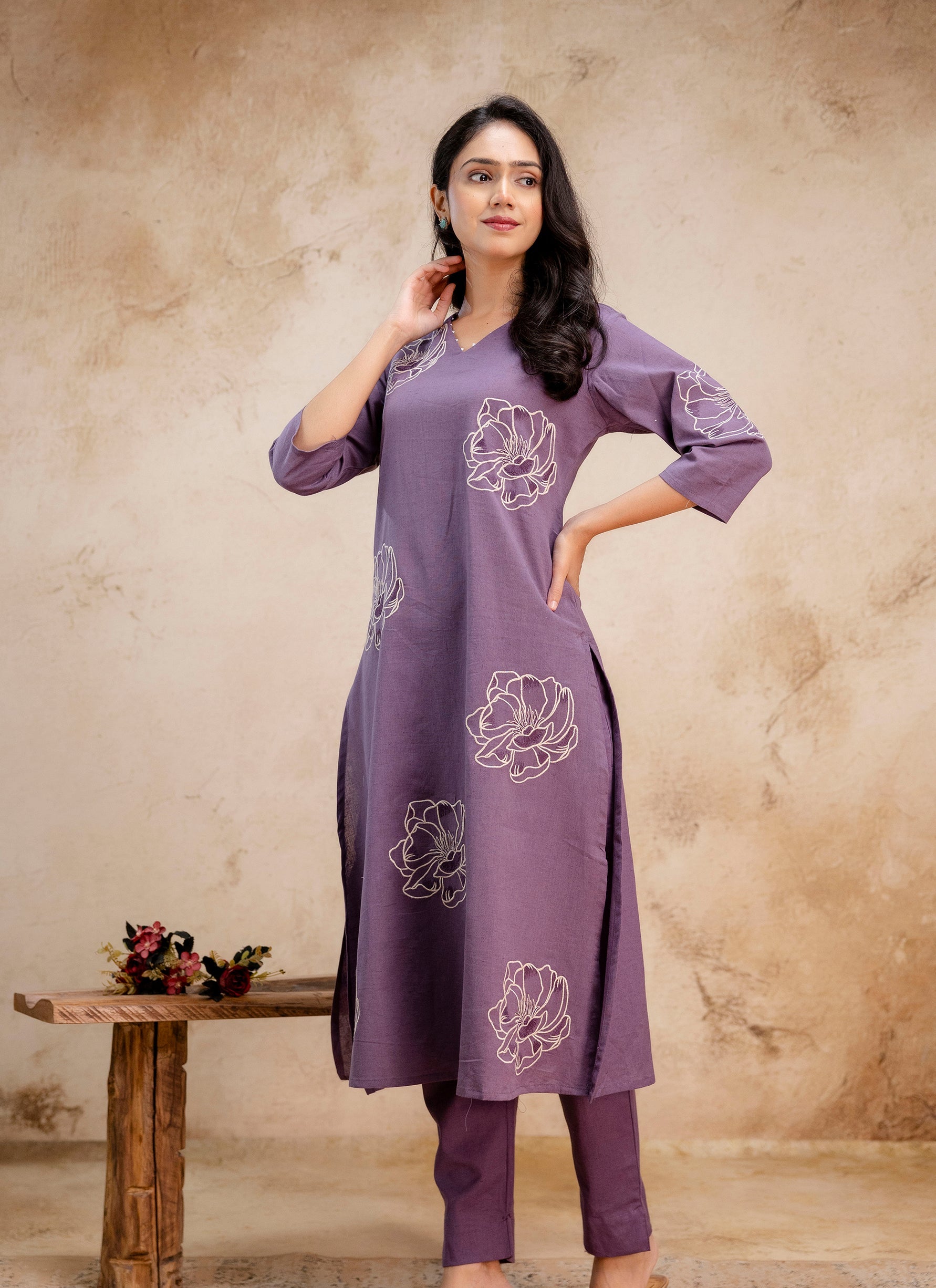 1. Tanauri lavender cotton kurti set with white floral motifs – confident standing pose  
2. Lavender embroidered kurti with pants from Tanauri – elegant ethnic look  
3. Stylish Tanauri cotton kurti in lavender with floral prints – three-quarter sleeves  
4. Tanauri lavender ethnic set with floral stitch pattern and side slit kurti  
5. Tanauri cotton kurti for women in lavender with artistic floral detailing  
6. Model in Tanauri lavender kurti and pants set – minimal, classy Indian wear  