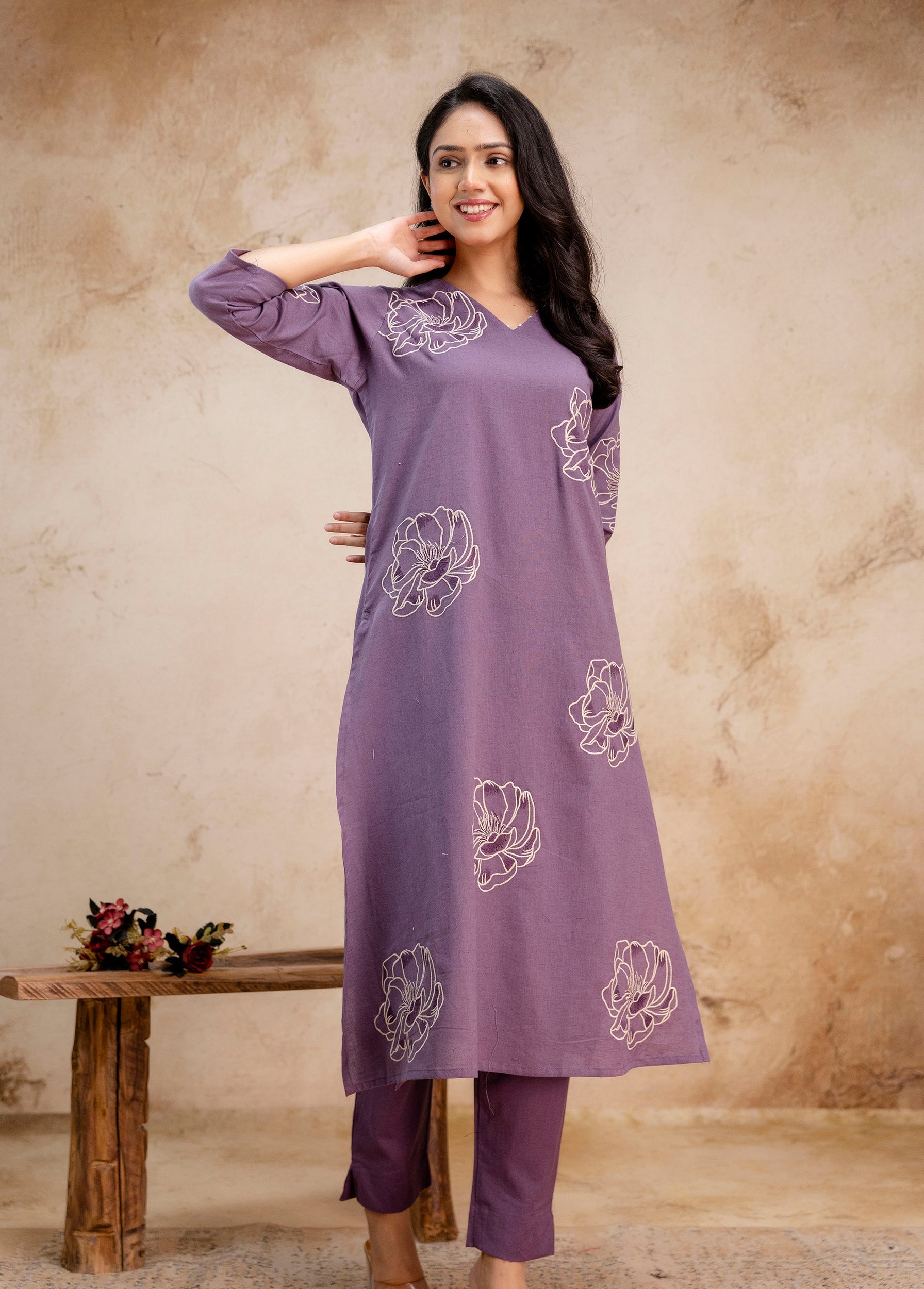 Tanauri lavender cotton kurti with white floral embroidery – hands raised, smiling
Elegant lavender Tanauri kurti and pants set with stitched floral motifs
Stylish sleeveless floral kurti in lavender from Tanauri – comfortable cotton wear
Lavender ethnic kurti set by Tanauri – casual Indian fashion for women
Tanauri cotton kurti in lavender shade with modern floral prints – joyful pose
Model in lavender Tanauri kurti outfit – soft cotton and floral embroidered
Floral cotton kurti and pant set in lavender 