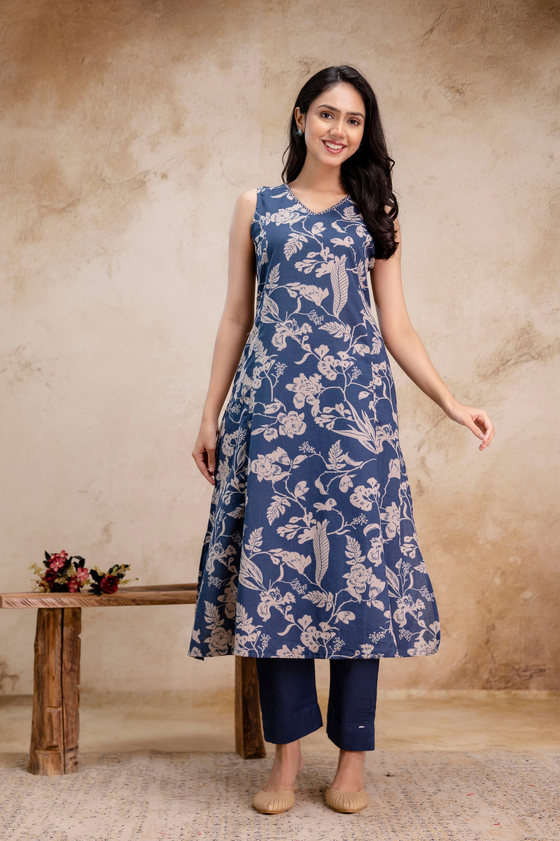 1. Indigo blue sleeveless kurti with beige floral print and straight pants  
2. Women’s sleeveless A-line kurti set in indigo cotton with ethnic motifs  
3. Front view of indigo printed kurti paired with solid navy blue pants  
4. Sleeveless cotton kurti with floral block print – casual ethnic wear  
5. Elegant indigo kurti and pants set for women – summer ethnic outfit  
6. Sleeveless floral indigo kurti in A-line cut with straight trousers  
7. Model wearing indigo cotton kurti set with traditional beige 