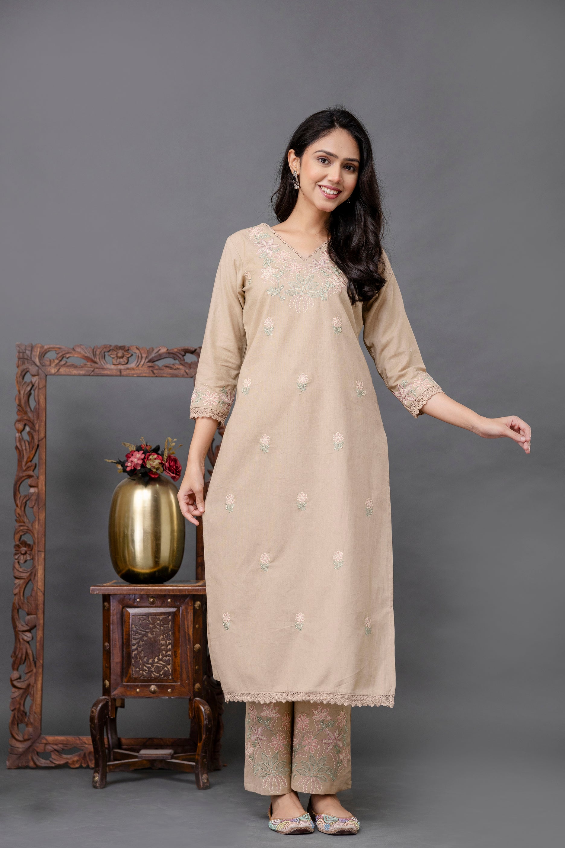 Elegant straight-cut kurti in soft beige tone

Delicate floral embroidery in pastel pink and green across the chest and scattered throughout the front

Intricately embroidered sleeve cuffs and hemline with lace detailing

Features a classic V-neck with subtle thread embellishments

Tailored from breathable cotton fabric for comfortable ethnic wear