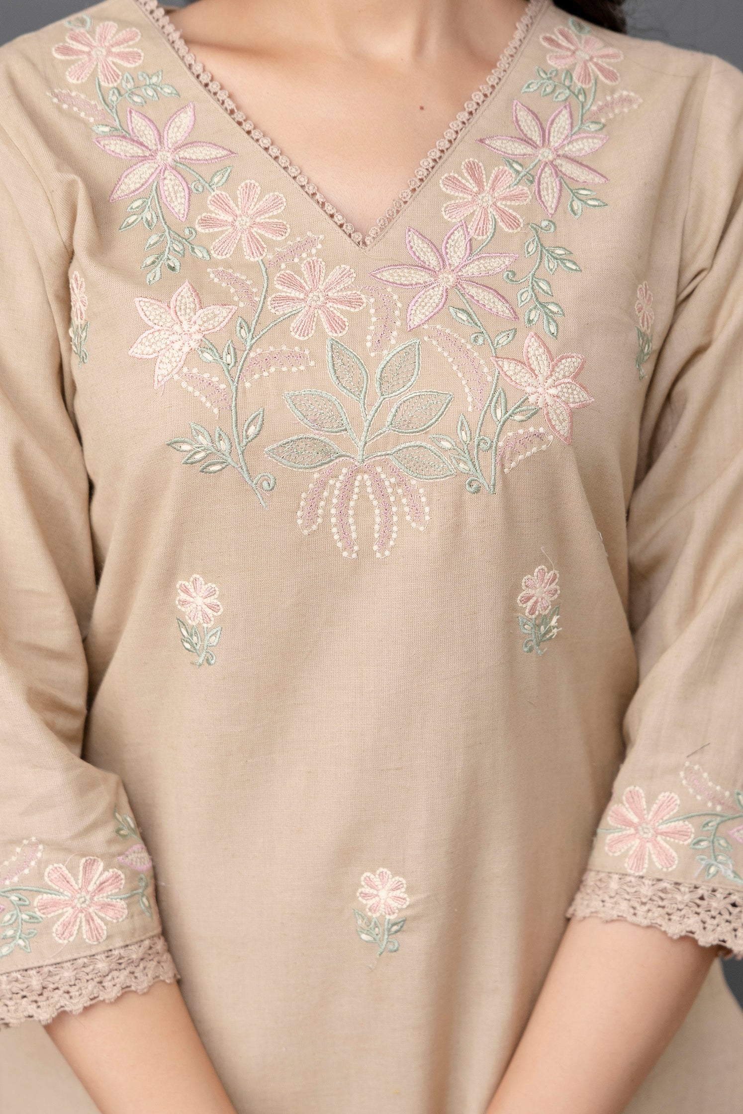 Beige-colored straight kurti with a subtle and elegant appearance

V-neckline highlighted with delicate thread embroidery

Intricate pastel floral embroidery on the chest and lightly scattered on the front panel

Elbow-length sleeves with detailed embroidered cuffs

Straight hem with soft lace border adding finesse

Made from breathable, lightweight cotton fabric – perfect for casual or semi-formal wear

