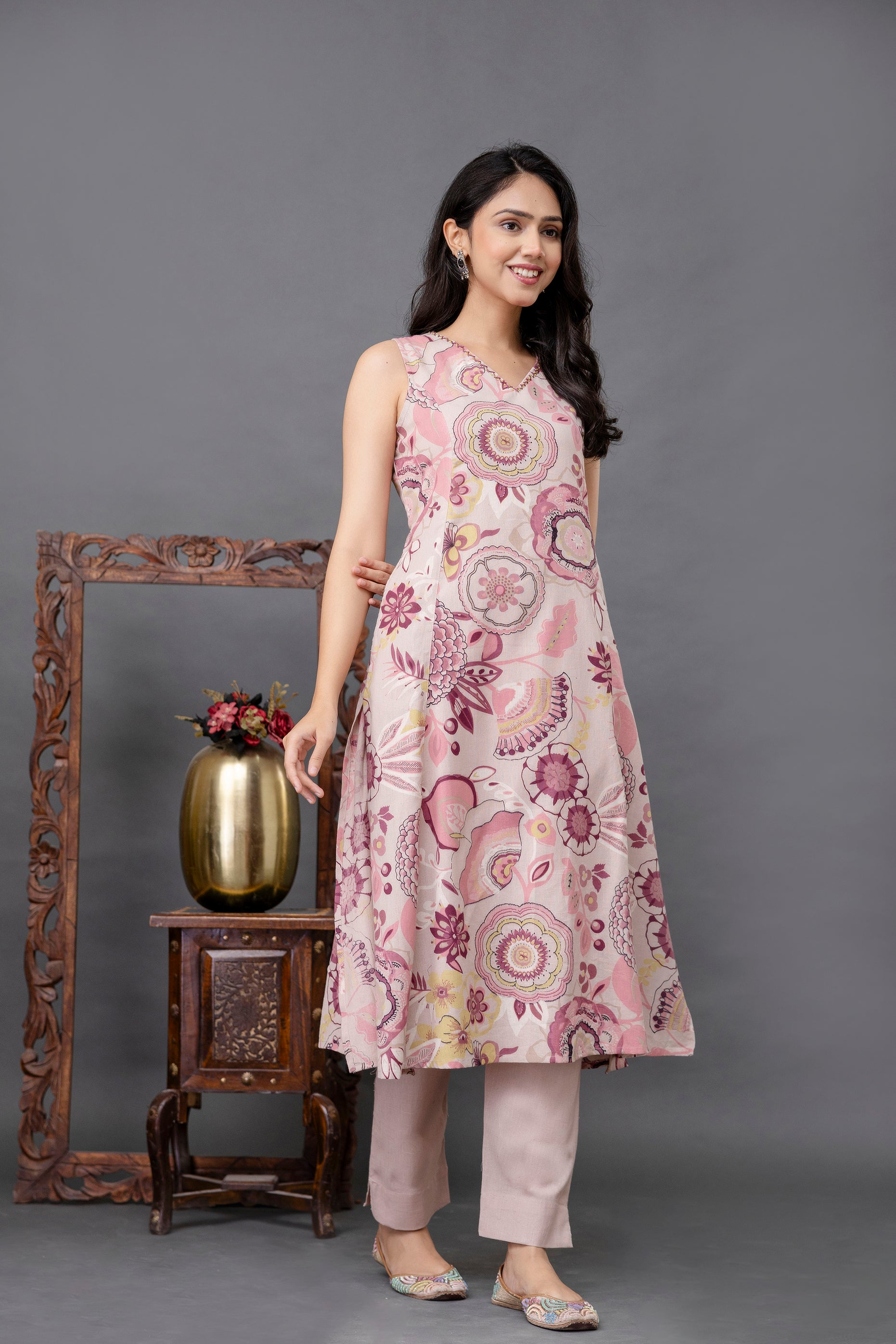 Elegant sleeveless A-line kurti in a soft pastel pink base

Adorned with bold mandala and floral motifs in shades of mauve, plum, and ivory

Features a clean round neckline with subtle side seam pockets

Light and breathable fabric, ideal for casual summer wear

Flowy silhouette offering both comfort and effortless ethnic style