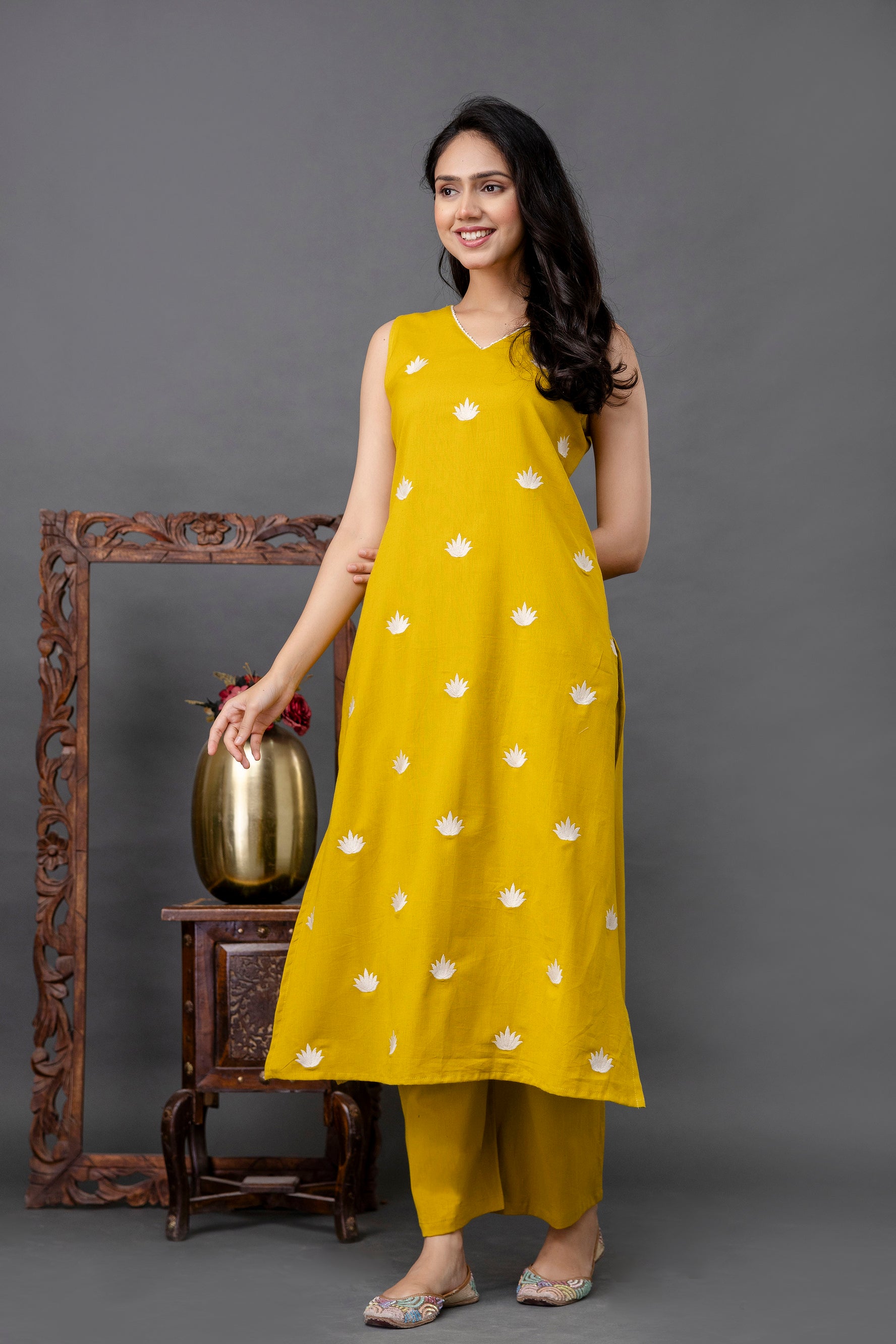 Sleeveless mustard yellow kurti with white lotus flower embroidery all over

V-neck design with a flowy A-line silhouette for a modern ethnic touch

Lightweight cotton fabric perfect for summer and daily comfort

Simple yet elegant styling ideal for casual and office wear

Subtle floral accents add a playful charm to the minimal look