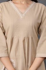 Light beige kurti crafted in soft, breathable cotton fabric. Features a V-neckline finished with delicate white zig-zag embroidery.