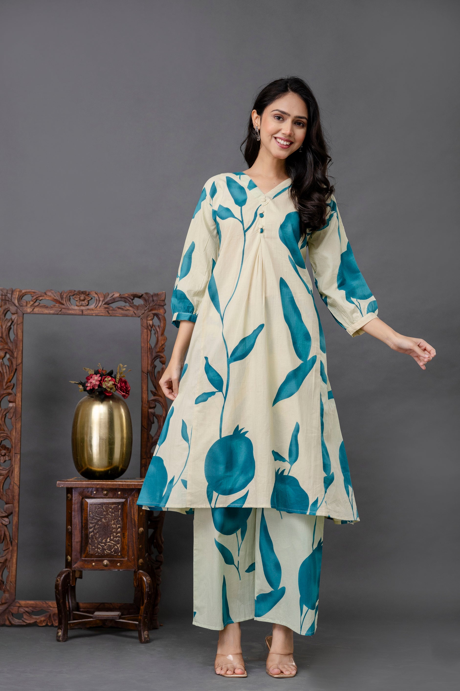 Cream kurti with teal leaf print

Botanical print kurti for women

Statement kurti with nature-inspired motifs

Three-quarter sleeve printed kurta set

Cotton kurti with bold blue pomegranate print

Elegant ethnic wear with artistic design

V-neck kurta with front pleats

Indo-western printed kurti set

Casual floral kurti for summer

Unique kurta with oversized plant pattern

Comfortable breathable kurti set

Modern botanical motif kurti

Nature-themed kurta with matching pants

Trendy co-ord kurta pant