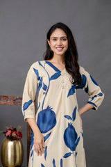 Woman wearing a beige kurta with large blue pomegranate print