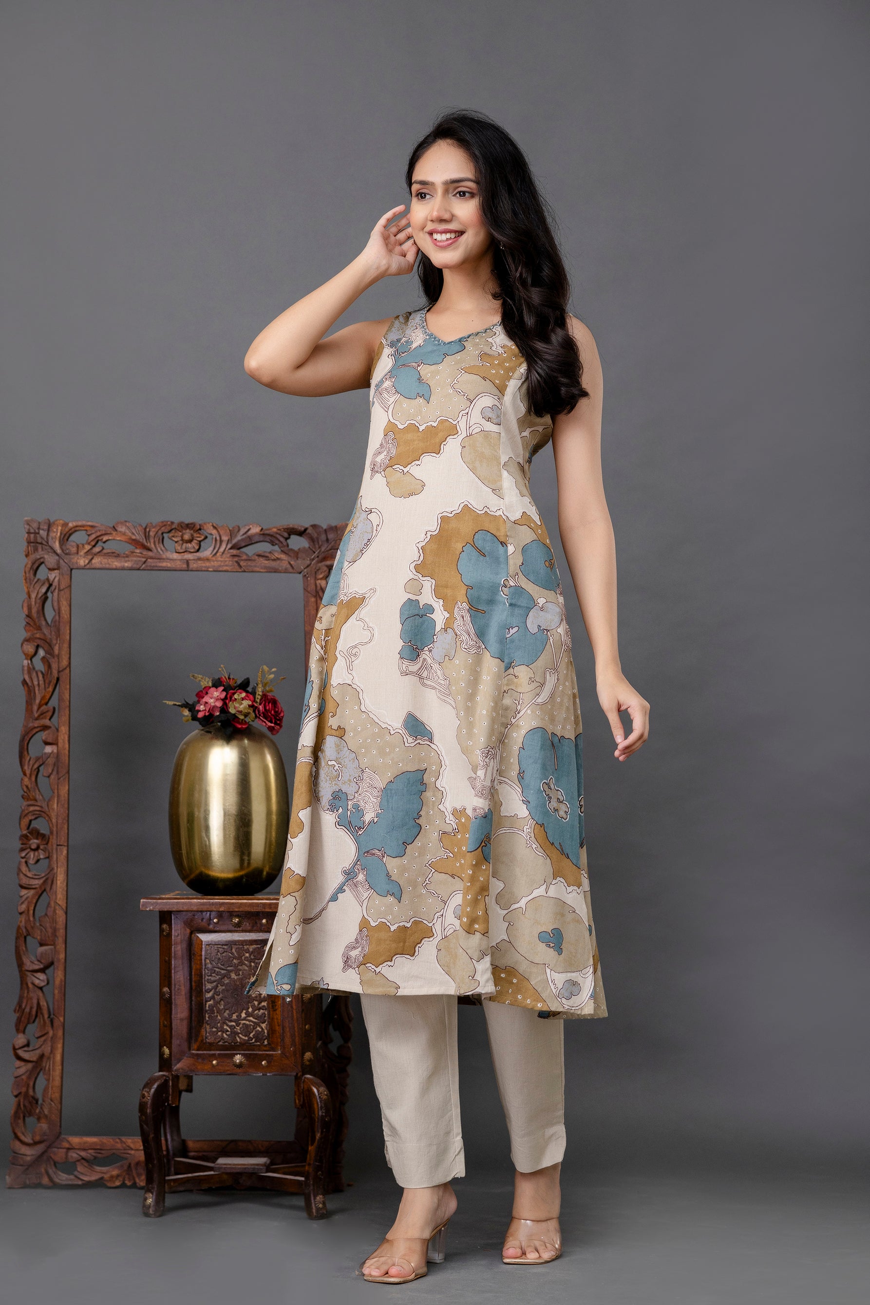 Sleeveless beige cotton kurti with artistic blue and mustard abstract floral print

Features a round neckline and a flowy A-line silhouette

Paired with matching cream straight-fit pants for a chic Indo-western appeal

Lightweight and breathable fabric ideal for summer or casual wear

Elegant printed kurti perfect for brunch, workwear, or day outings