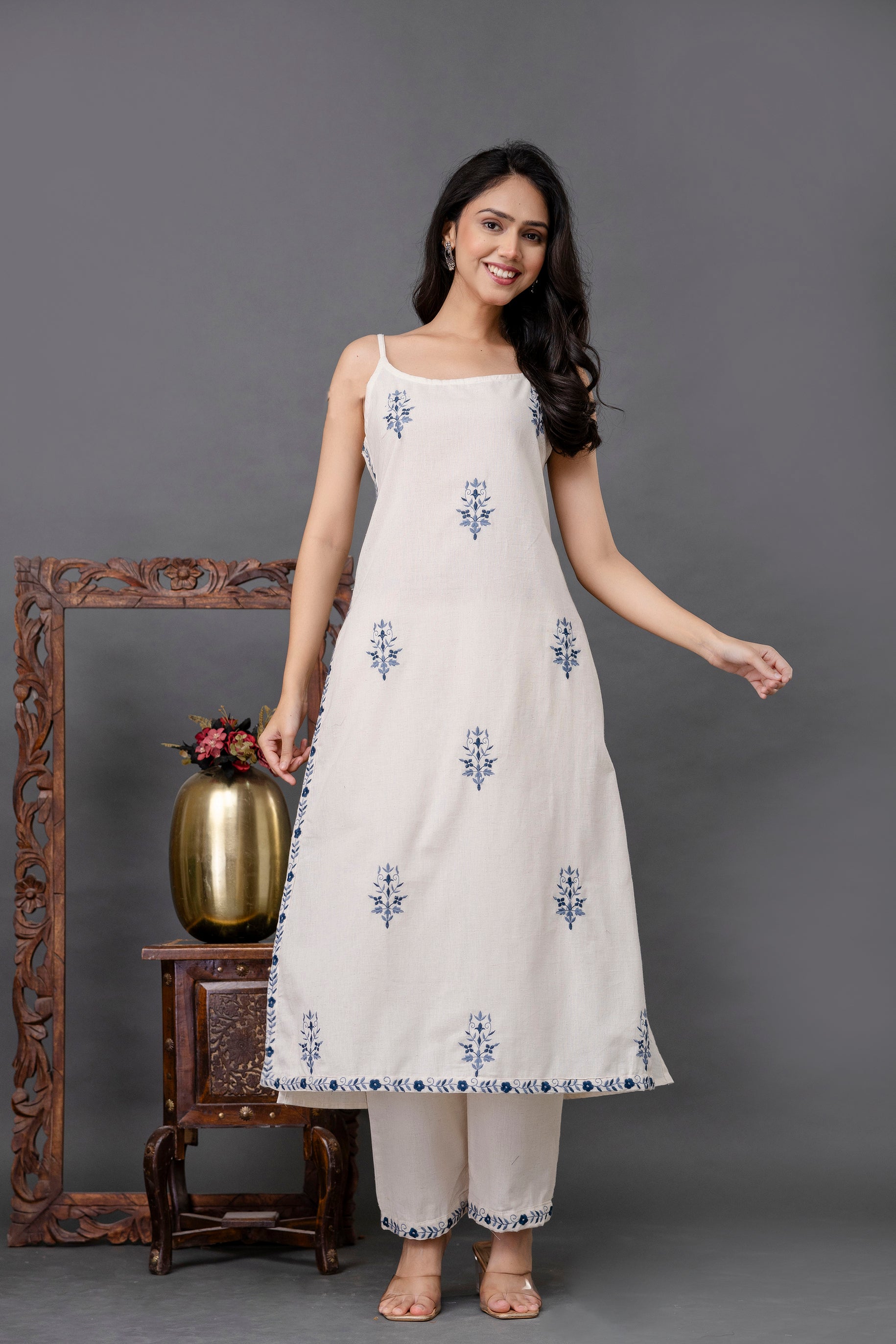Sleeveless white cotton kurti with blue floral hand-block prints

Subtle A-line silhouette for a breezy and flattering fit

Delicate blue printed border along hemline and pant cuffs

Paired with straight white cotton pants for a complete ethnic look

Ideal for summer outings, casual daywear, and minimalistic fashion lovers