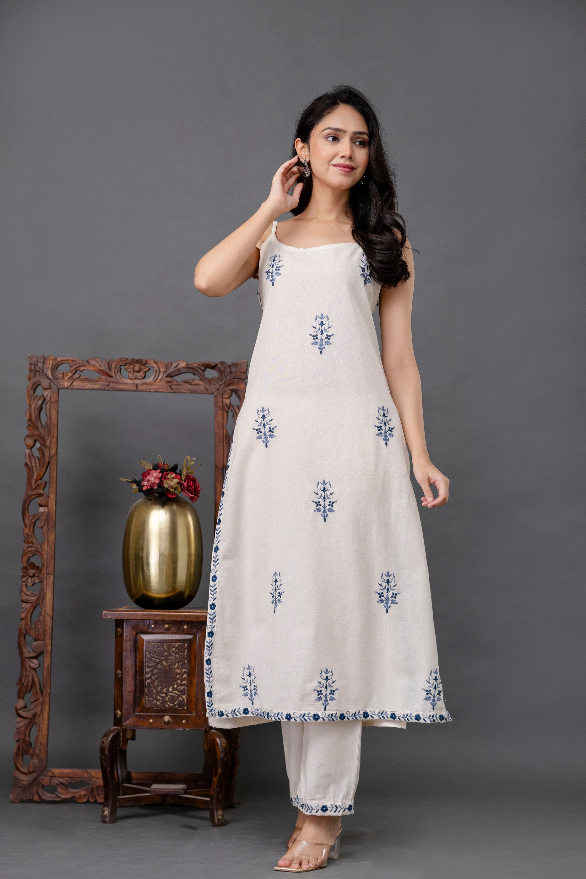 White sleeveless kurti with delicate blue floral motifs

Crafted in lightweight cotton for breathable comfort

Straight-cut silhouette with side slits for ease of movement

Subtle printed border detailing at the hem

Elegant ethnic wear perfect for casual summer looks or daytime events