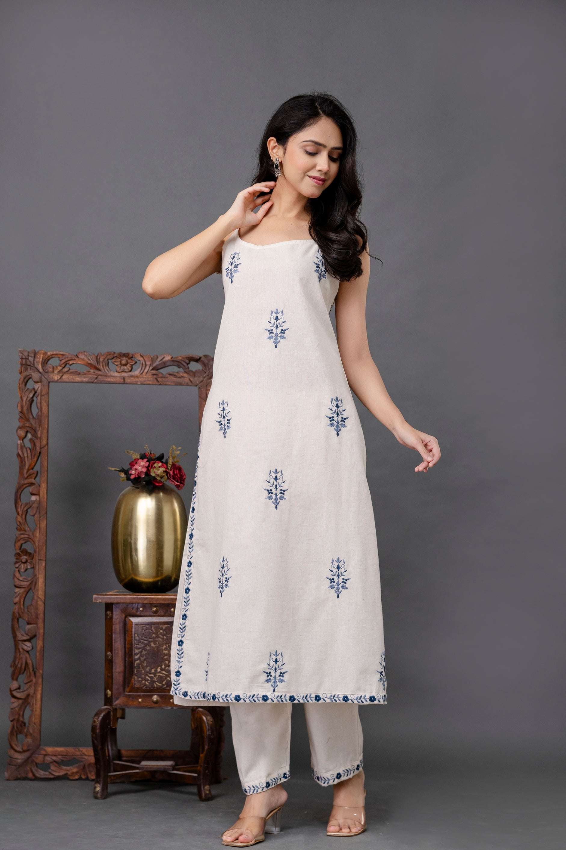 Sleeveless ivory kurti with elegant navy floral embroidery

Soft cotton fabric with a breezy, A-line silhouette

Minimalist design enhanced with detailed border work on hem and sides

Traditional ethnic wear with a modern, sleeveless twist

Ideal summer kurti for casual outings, festive gatherings, and daily wear