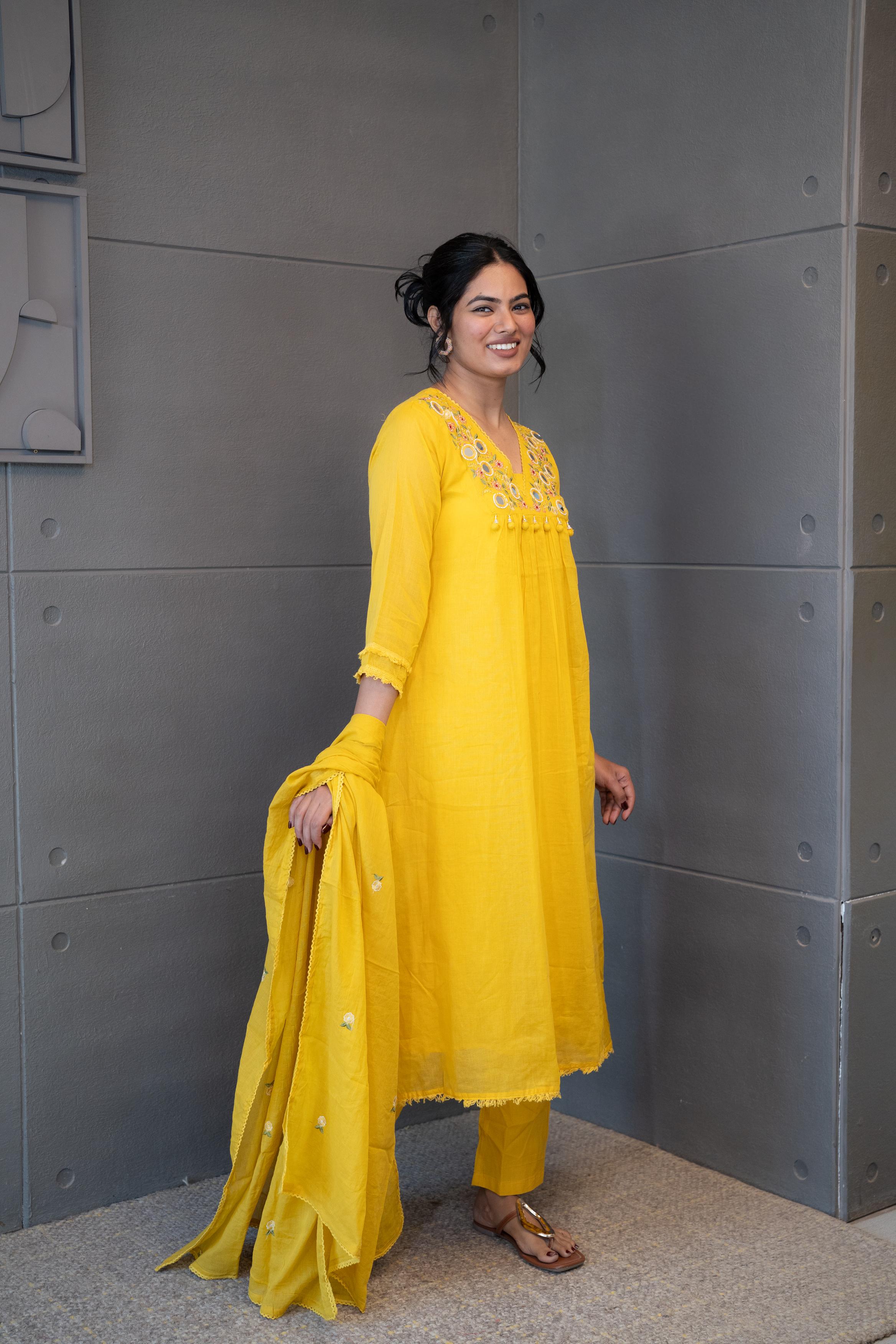 Marigold Magic Dupatta Set by Tanauri: Yellow cotton three-piece suit with embroidered V-neckline and matching textured dupatta.