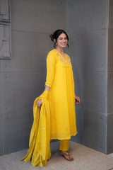 Marigold Magic Dupatta Set by Tanauri: Yellow cotton three-piece suit with embroidered V-neckline and matching textured dupatta.