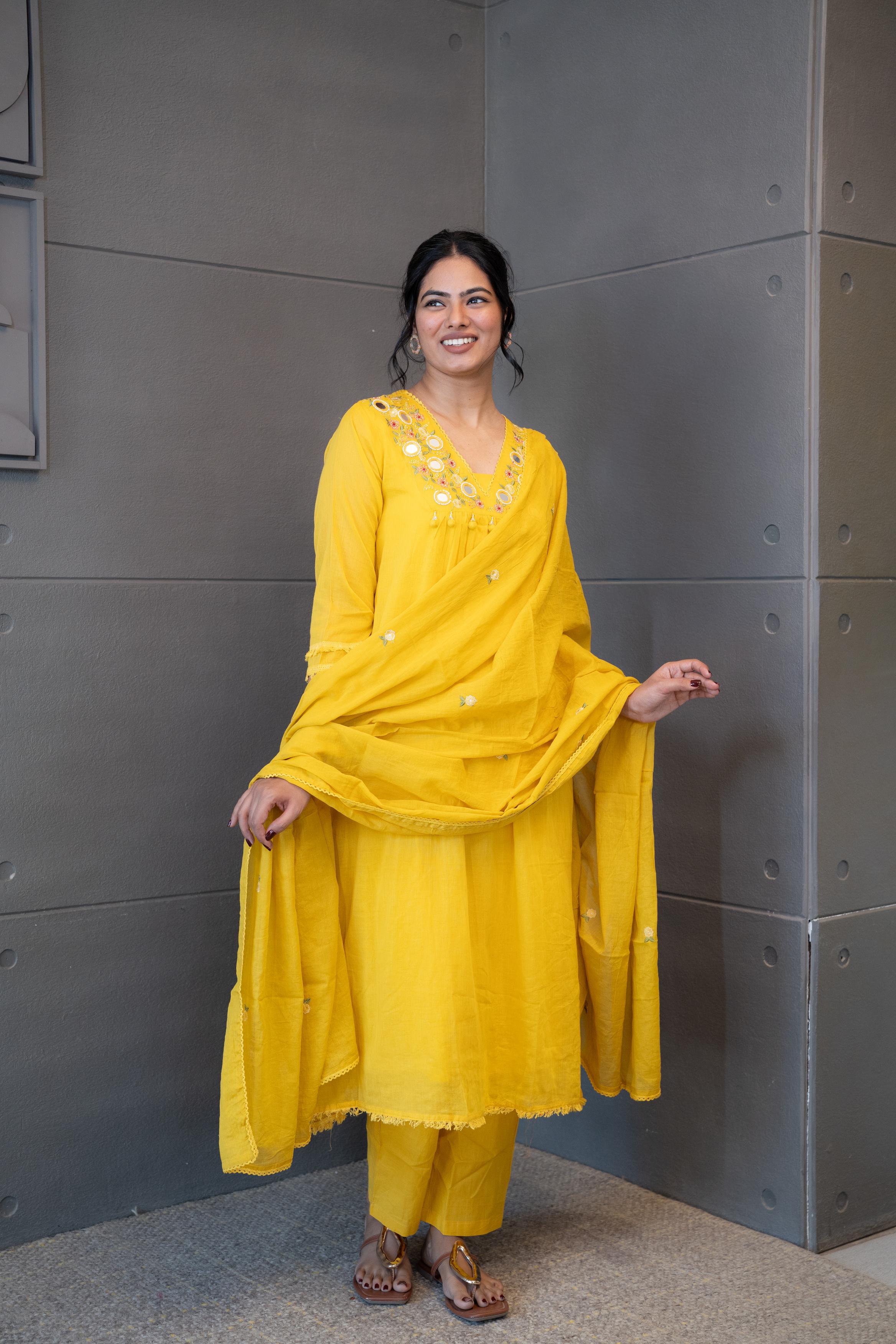 Marigold Magic Dupatta Set with delicate vibrant yellow suit with mirror work and floral embroidery by Tanauri