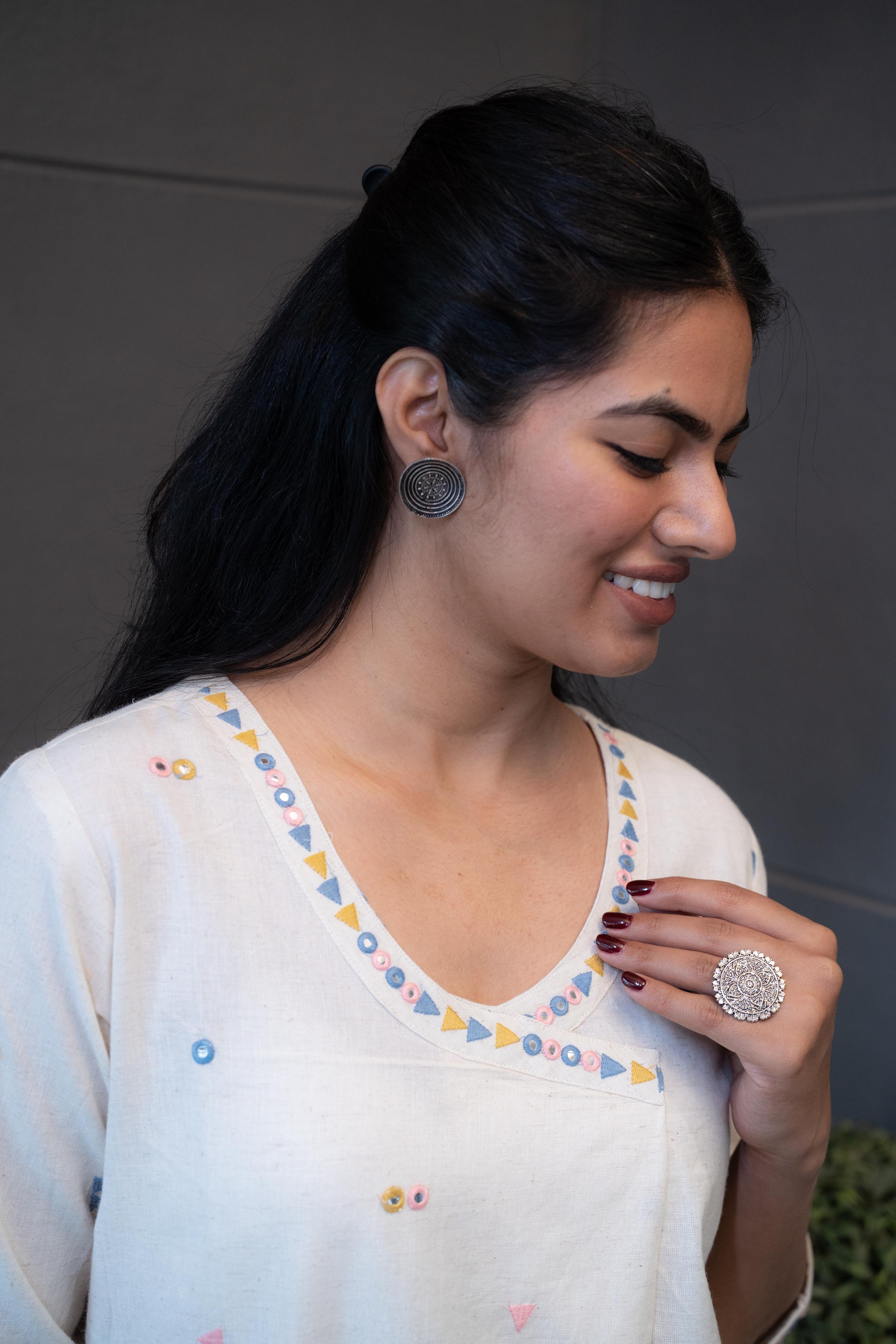 Model wearing Tanauri Geometric Embroidered Cream Kurta Set, displaying full view of kurti with geometric embroidery and matching cream pants in a casual setting