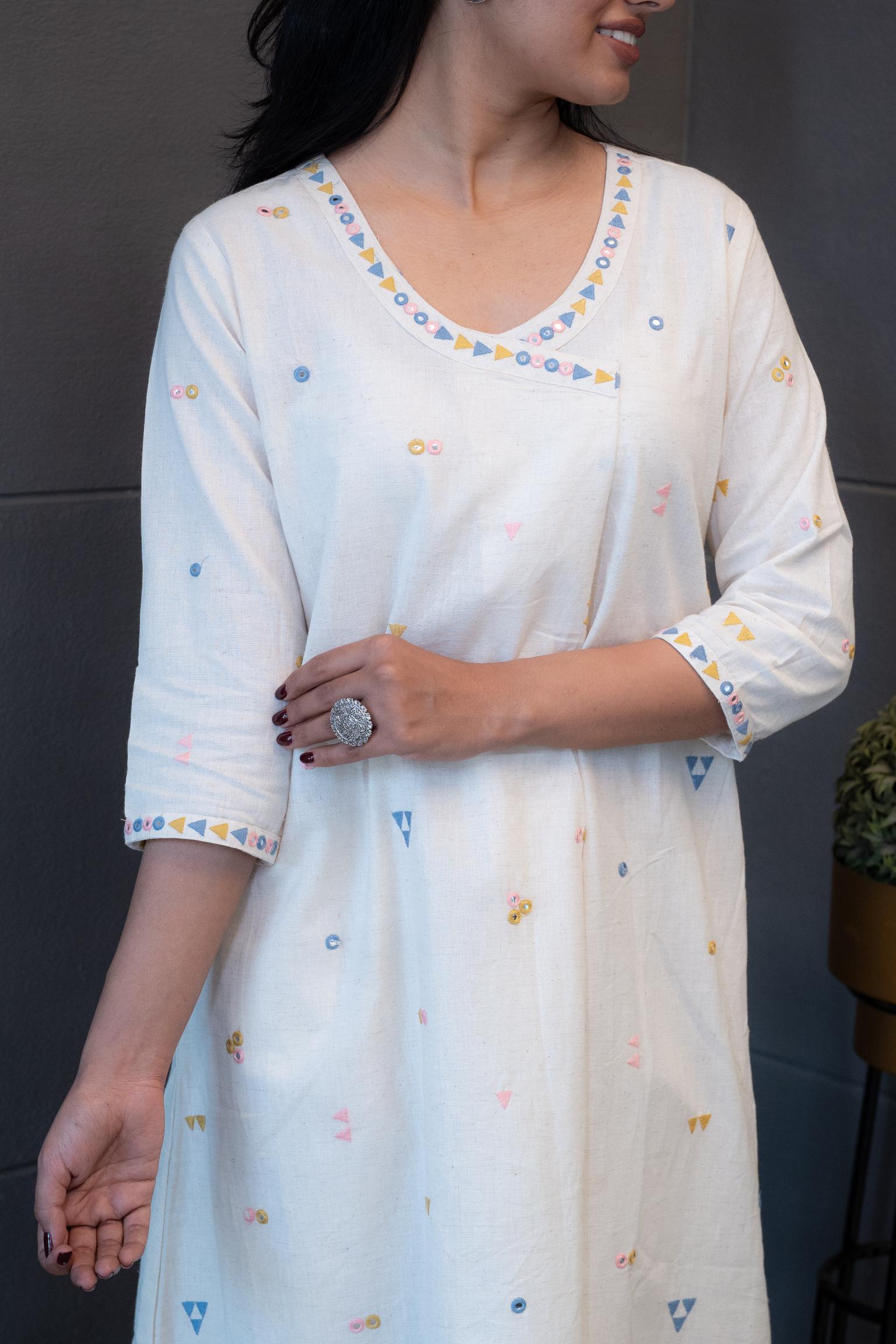 Texture shot of the soft, breathable cream cotton fabric of the Tanauri Geometric Embroidered Kurta Set