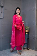 A woman modeling 'Noori Dupatta Set' by Tanauri, featuring a pink cotton kurti and trousers with delicate floral embroidery, holding a textured, pink dupatta