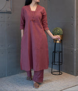 Model elegantly posing in Tanauri Mauve Melange Kurta Set, highlighting the lace and sequin details and full silhouette of the kurti and matching pants
