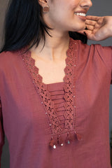 Model elegantly posing in Tanauri Mauve Melange Kurta Set, highlighting the lace and sequin details and full silhouette of the kurti and matching pants