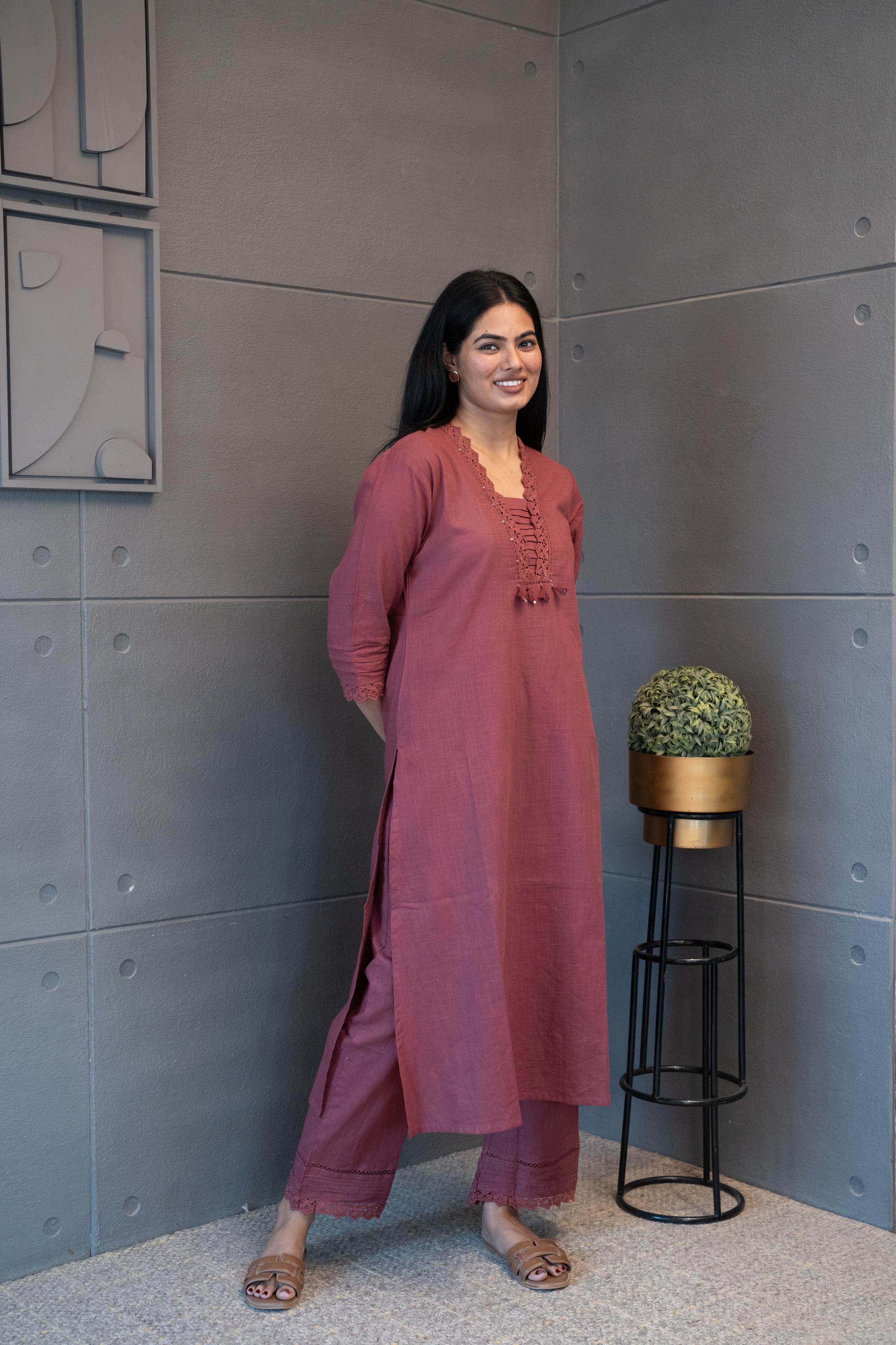 Tanauri Mauve Melange Kurta Set, folded in packaging, showcasing intricate lace and sequin embellished neckline with tassels on a textured cotton kurti