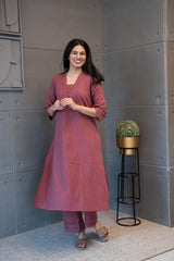 Tanauri Mauve Melange Kurta Set, folded in packaging, showcasing intricate lace and sequin embellished neckline with tassels on a textured cotton kurti
