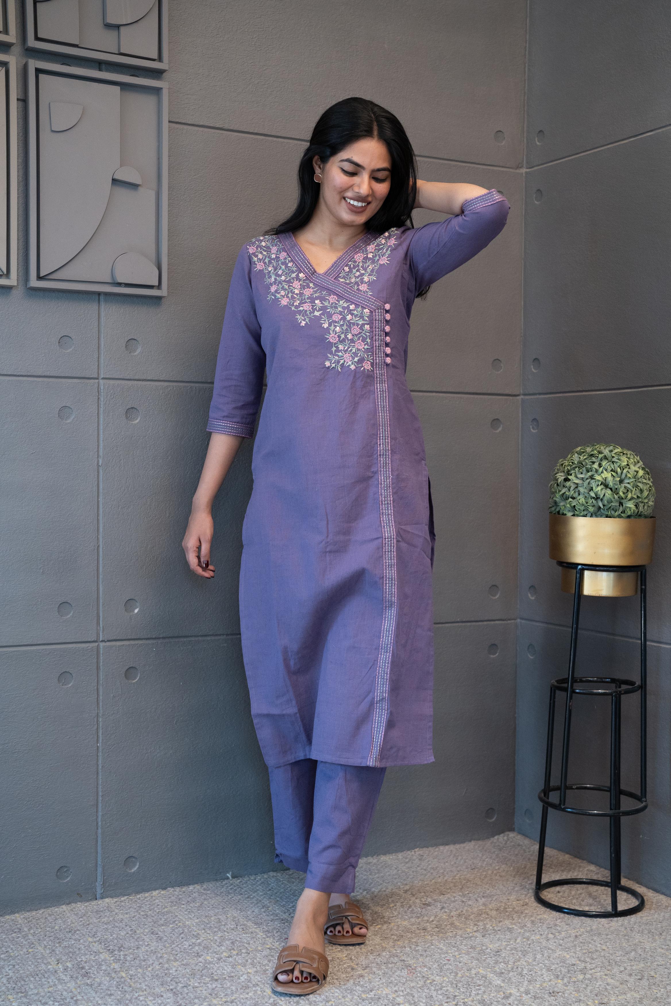 A woman modeling 'The Jamuni Kurta Set' by Tanauri, featuring a purple cotton kurti and trousers with delicate floral thread embroidery