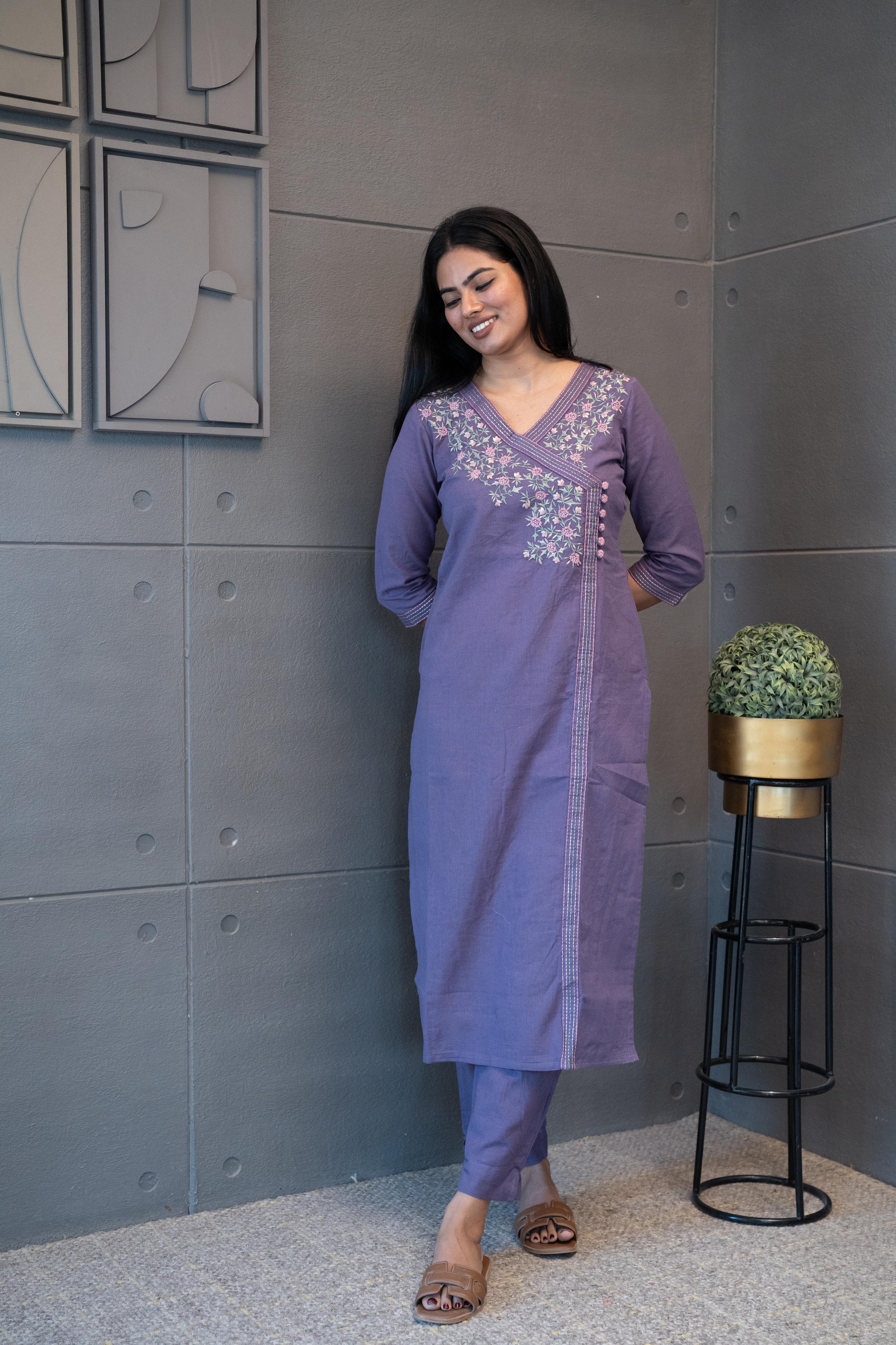 A woman modeling 'The Jamuni Kurta Set' by Tanauri, featuring a purple cotton kurti and trousers with delicate floral thread embroidery