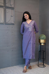 A woman modeling 'The Jamuni Kurta Set' by Tanauri, featuring a purple cotton kurti and trousers with delicate floral thread embroidery