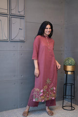 Tanauri Mauve Deer Delight Kurta Set, folded in packaging, showing hand-embroidered pink and green floral details on a cotton kurti