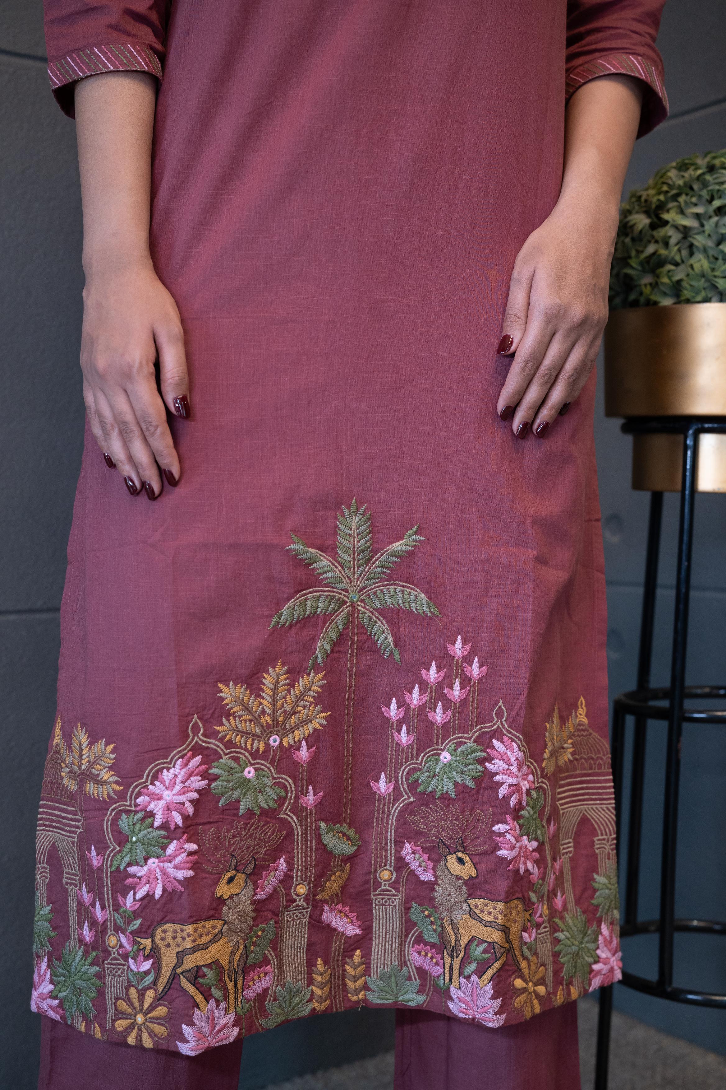 Close-up of hand-embroidered pink and green floral pattern on the mauve cotton fabric of the Tanauri Deer Delight Kurta