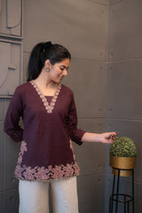 Ethnic short kurti in maroon featuring intricate neckline embroidery
