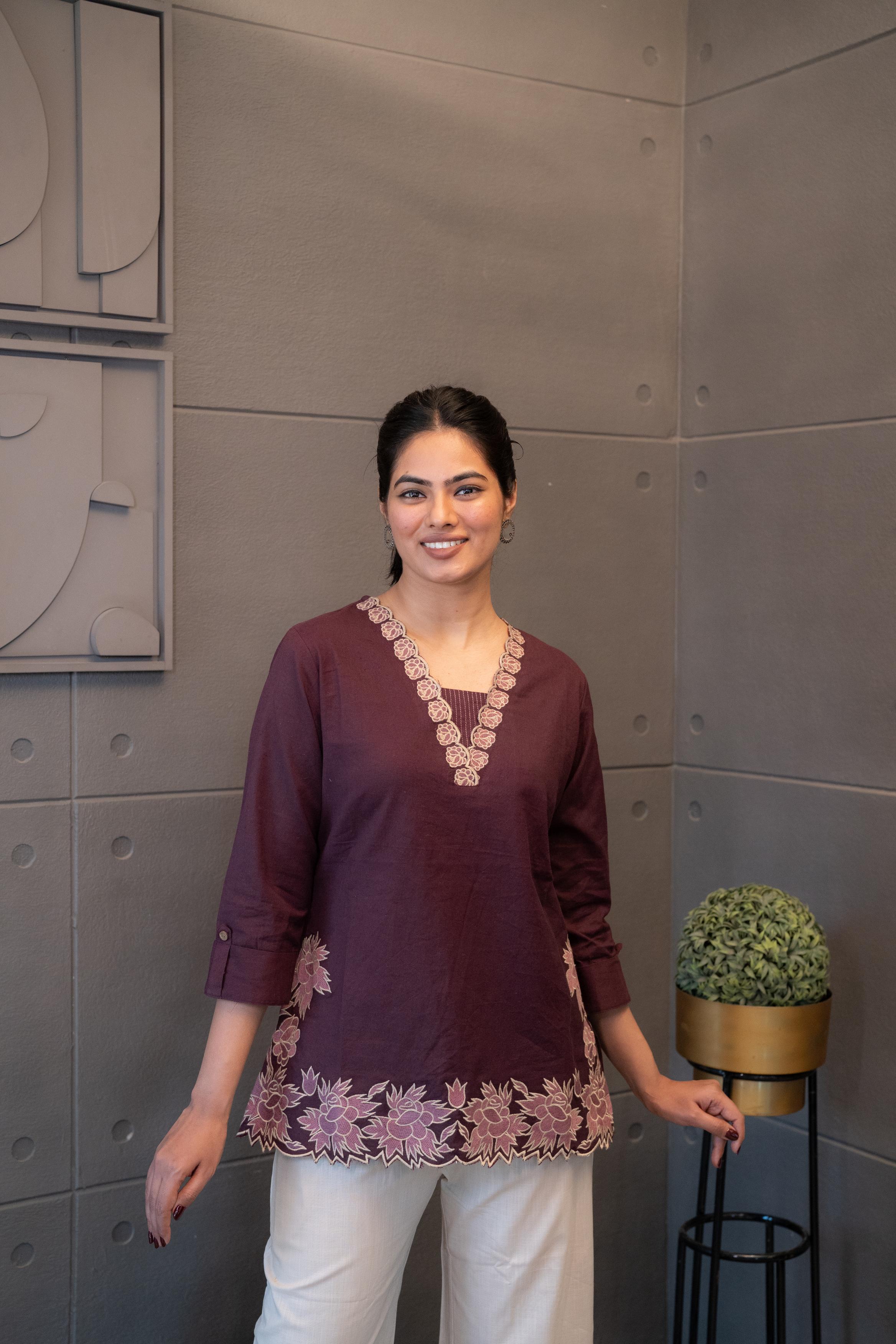 Ethnic short kurti in maroon featuring intricate neckline embroidery