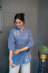 Detailed view of the blue cotton fabric texture and the stylish band collar with buttons on the Tanauri Blue Pop Short Kurti/Top