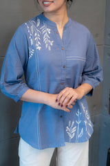 Close-up of the exquisite white leafy embroidery on the blue fabric of the Tanauri Blue Pop Short Kurti/Top, highlighting the intricate patterns