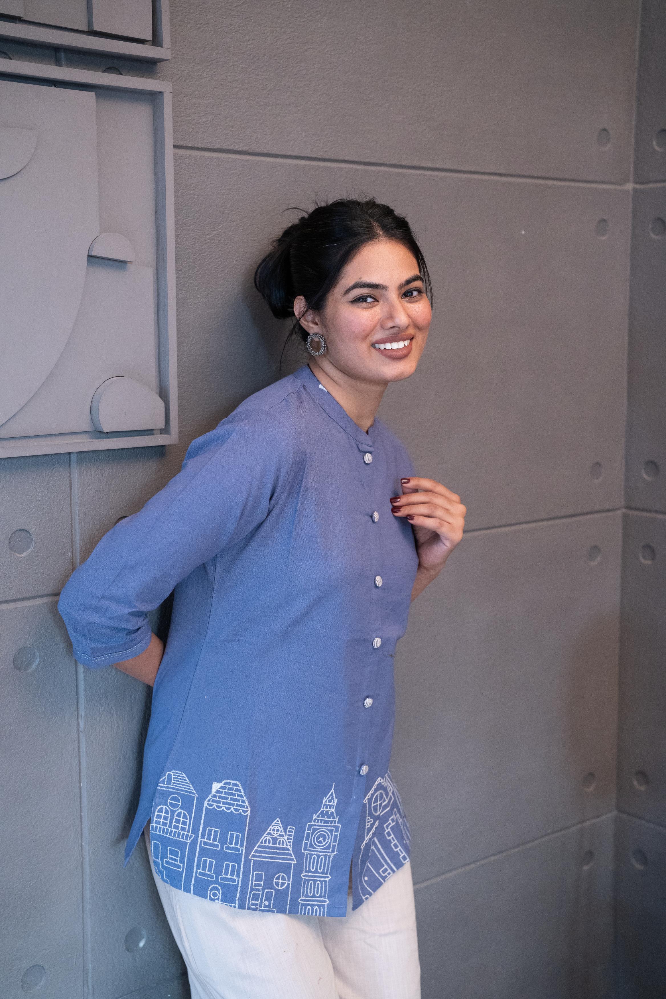 Detailed view of the soft, breathable periwinkle blue cotton fabric texture of the Tanauri Blue Cityscape Short Kurti/Top