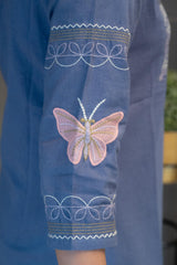 Detailed view of the blue cotton fabric texture and the stylish band collar with buttons on the Tanauri Orchid Short Kurti/Top