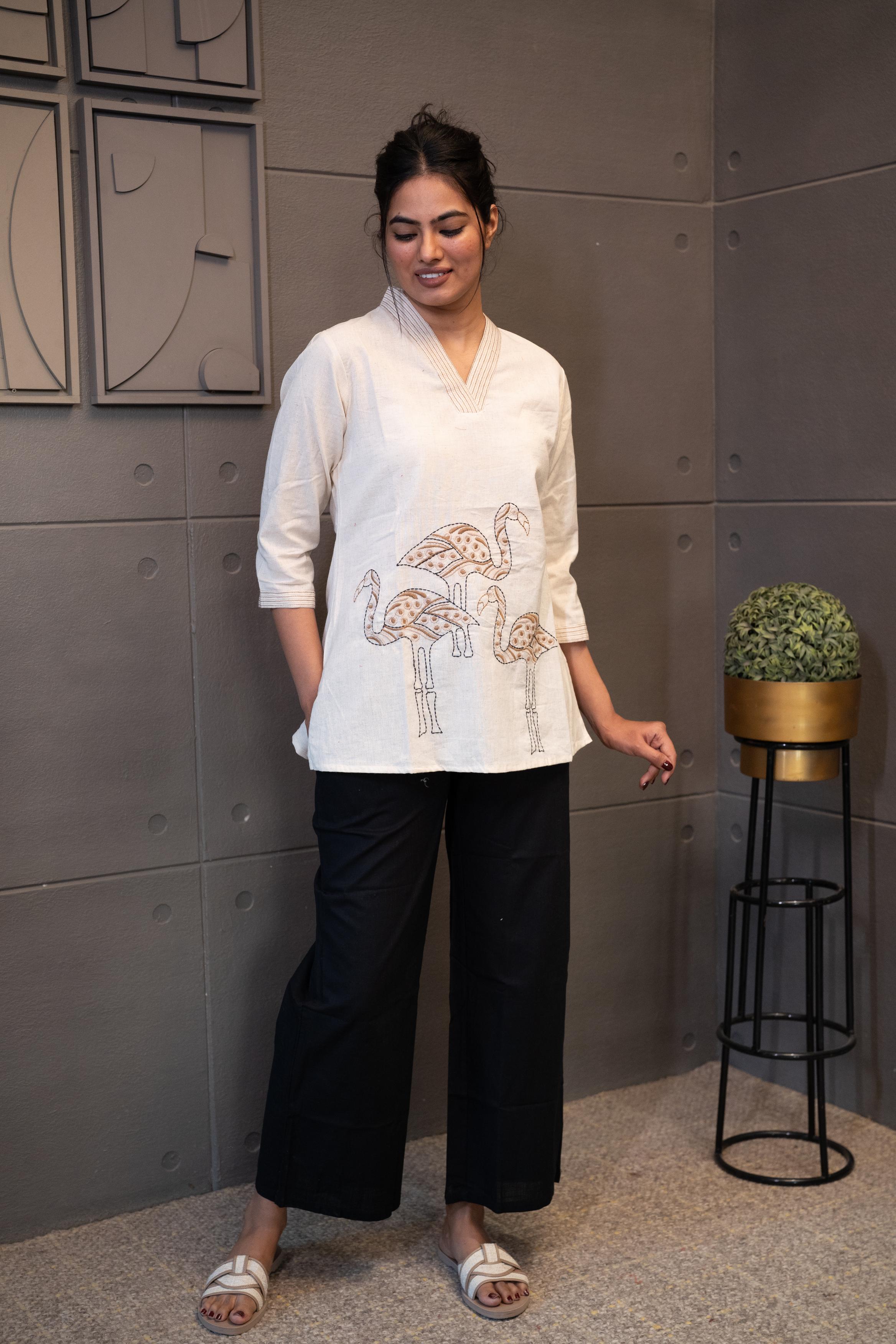 Detailed view of the soft, breathable cream cotton fabric texture of the Tanauri Swan Short Kurti/Top