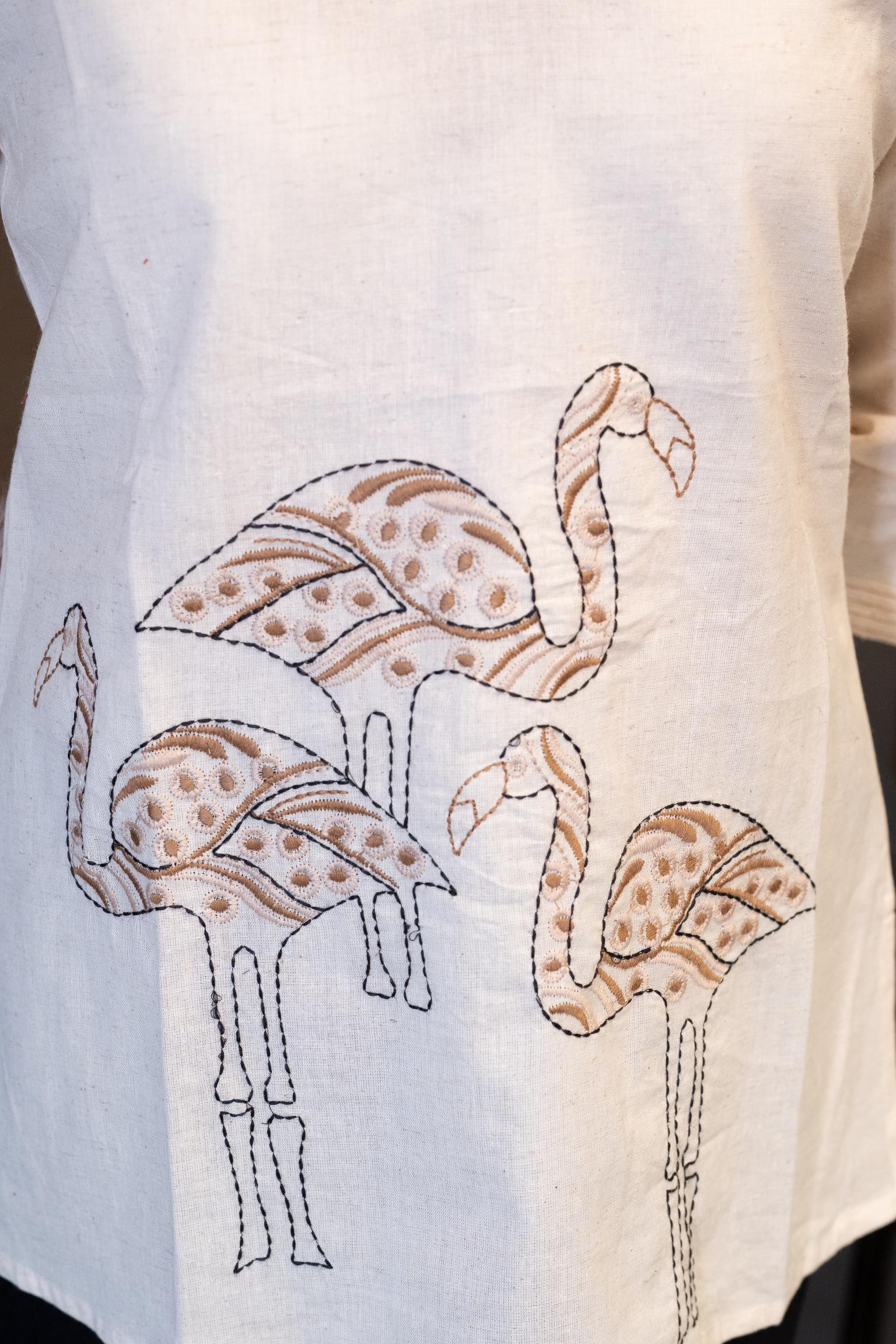 Close-up of the V-neckline of the Tanauri Swan Short Kurti/Top, highlighting the subtle vertical stitched texture