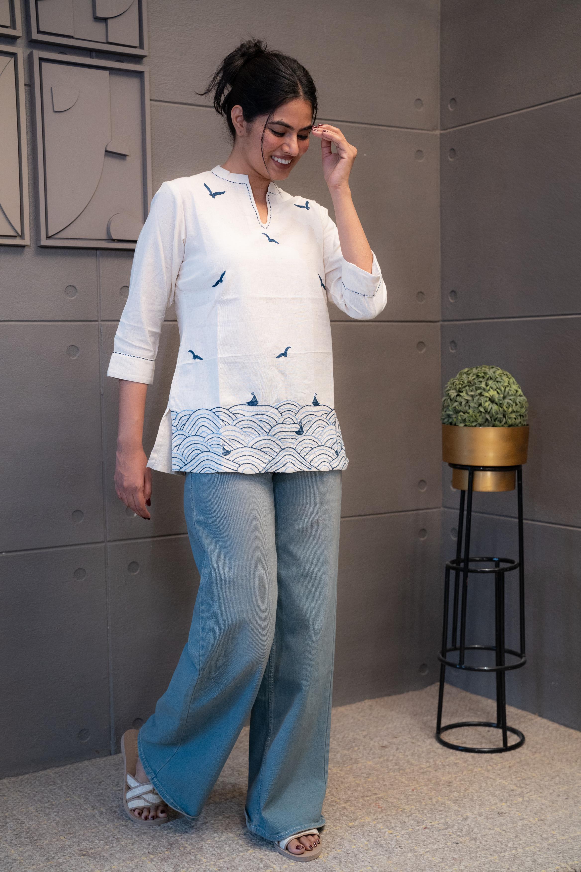 Detailed view of the soft, breathable cream cotton fabric texture of the Tanauri Blue Bird Short Kurti/Top