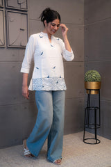 Detailed view of the soft, breathable cream cotton fabric texture of the Tanauri Blue Bird Short Kurti/Top