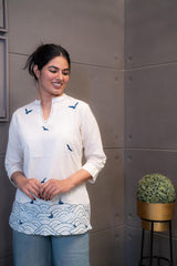 anauri Blue Bird Short Kurti/Top, folded in clear packaging, showcasing an off-white cotton tunic with blue bird motifs and blue V-neck stitching