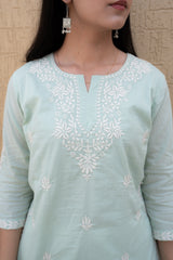 Light blue kurta with white embroidery on a beige background
