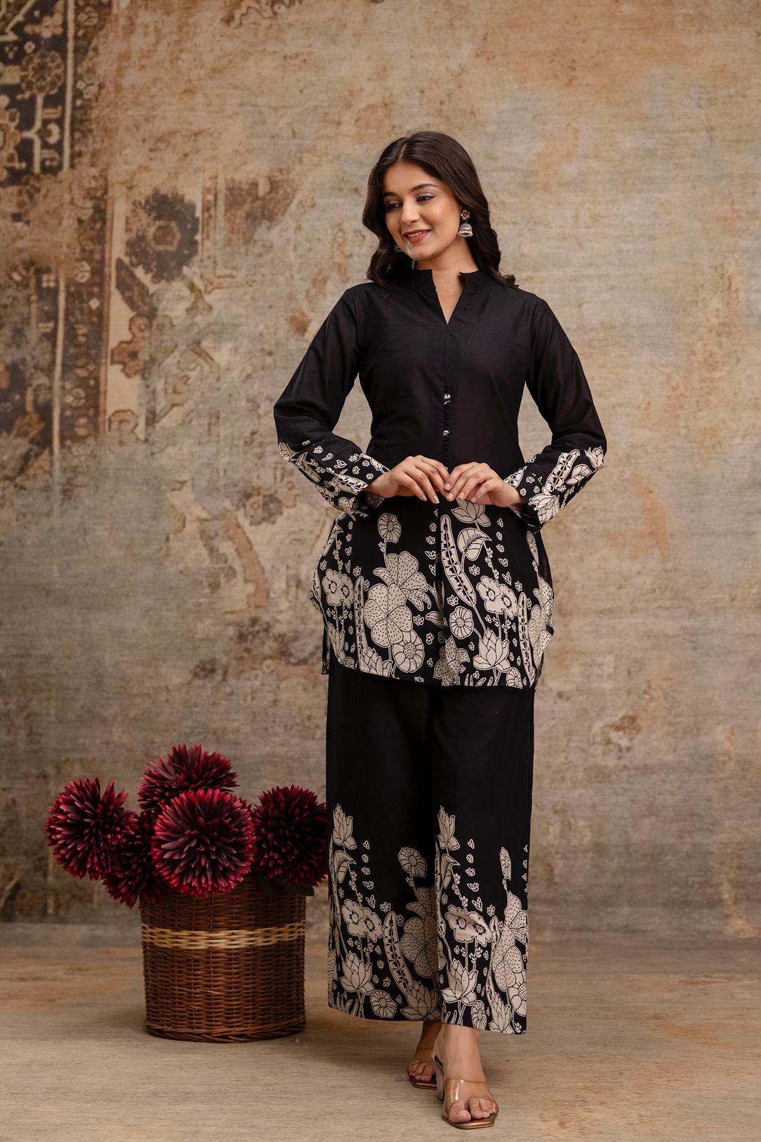 1. Front view of black cotton kurti and pant co-ord set with white floral print  
2. Black ethnic wear set for women with block printed kurti and wide-leg pants  
3. Elegant black kurti set with floral sleeves and hem – front full-length pose  
4. Traditional two-piece black co-ord outfit with handcrafted buttons  
5. Model wearing black ethnic kurti and trousers with floral border print  
6. Stylish black cotton kurti and pant set with long sleeves and side slit  
7. Black co-ord kurti set with mandarin 